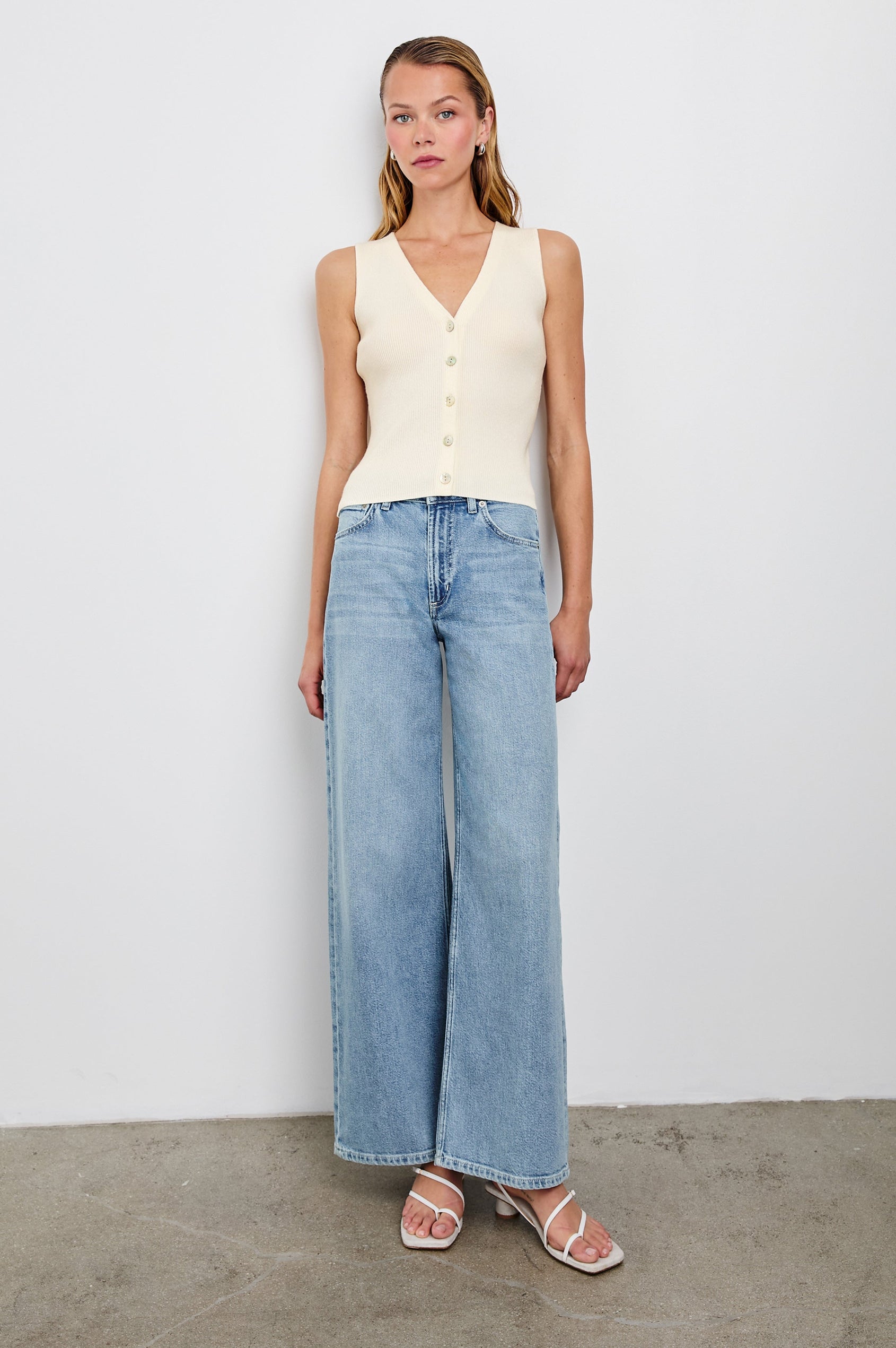 Rosa Ribbed Sleeveless Vest with a V Neckline and Buttons Down the Front in Ivory Colorway - Front Full Body View Featured on Model