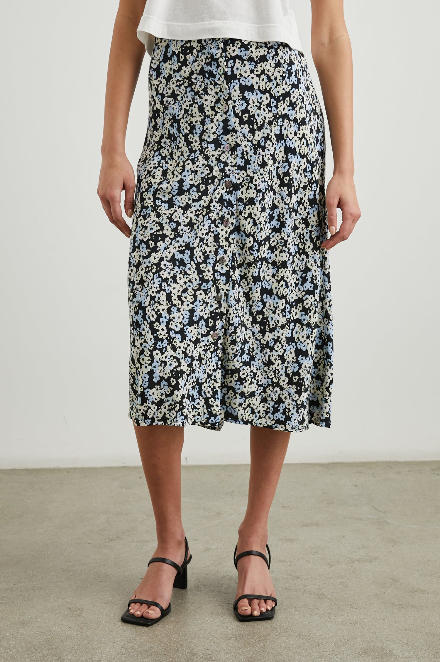 Rosetta Midi Skirt with Buttons Down the Front in Midnight Meadow Floral Colorway, blue and white flowers on Midnight - Front View Featured on Model 