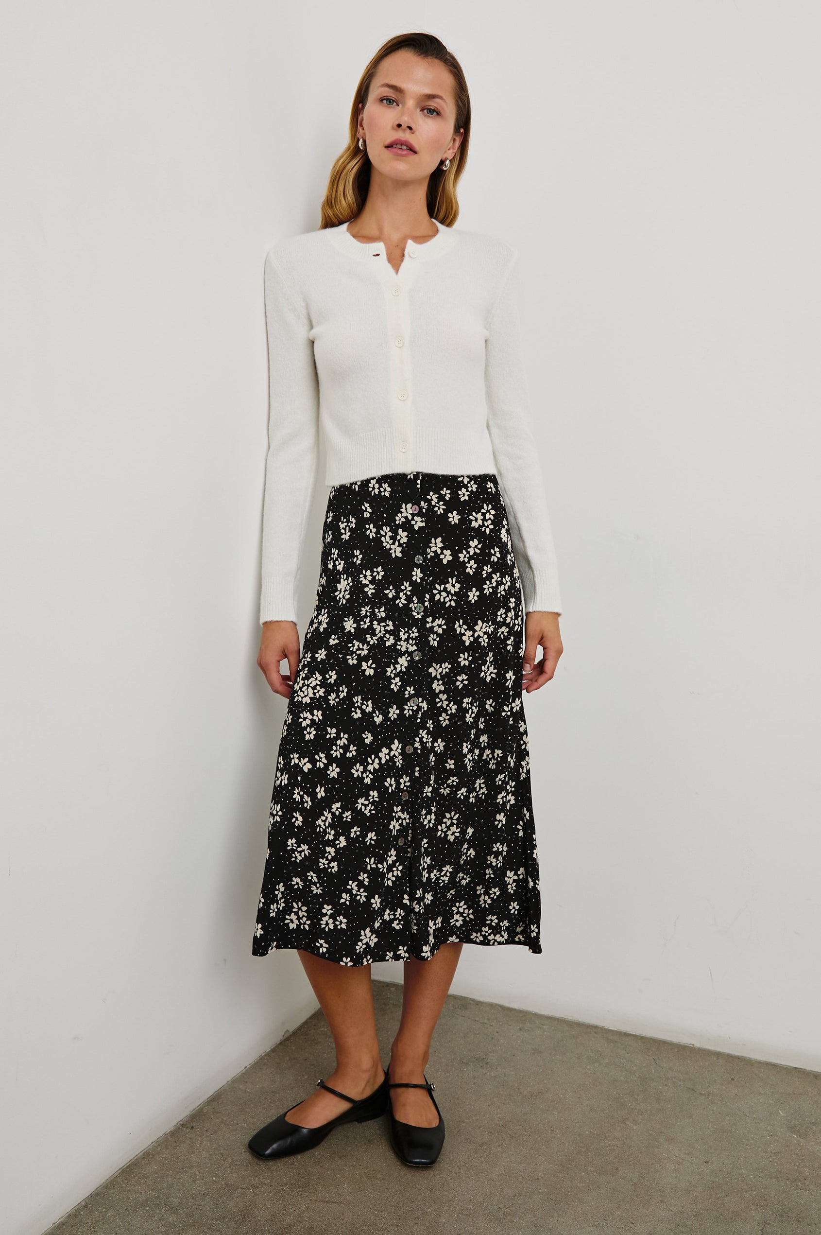 Rosetta Midi Skirt with Buttons Down the Front in Noir Floral Colorway, white flowers on black - Front Full Body View Featured on Model 