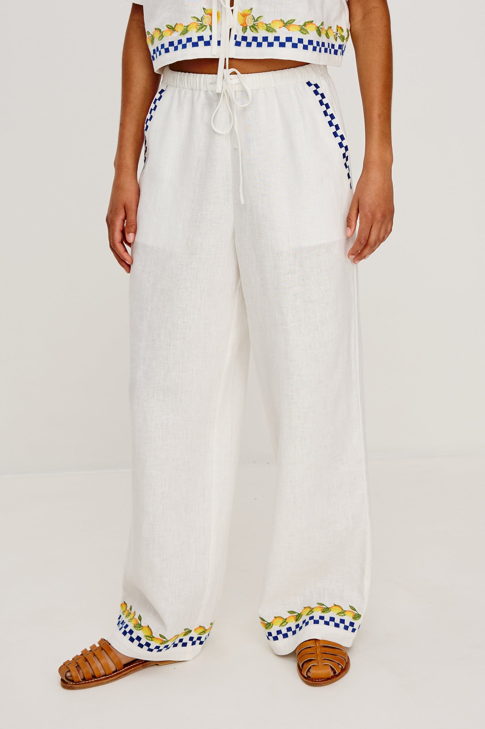 Rosita linen pant in Sorrento Embroidery colorway featuring side pockets, drawstring waist, and Italian inspired embroidery - front view on model