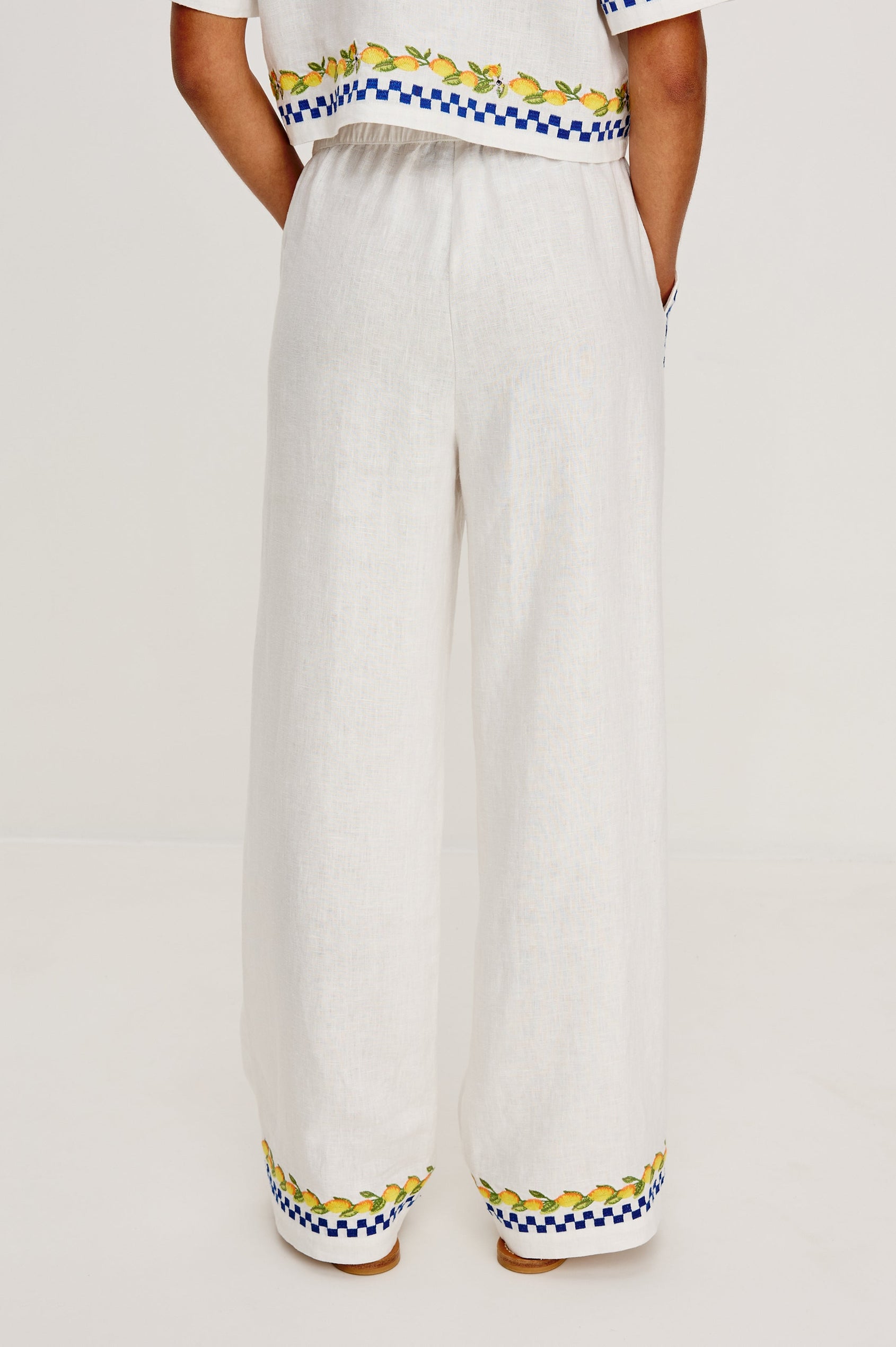Rosita linen pant in Sorrento Embroidery colorway featuring side pockets, drawstring waist, and Italian inspired embroidery - back view on model