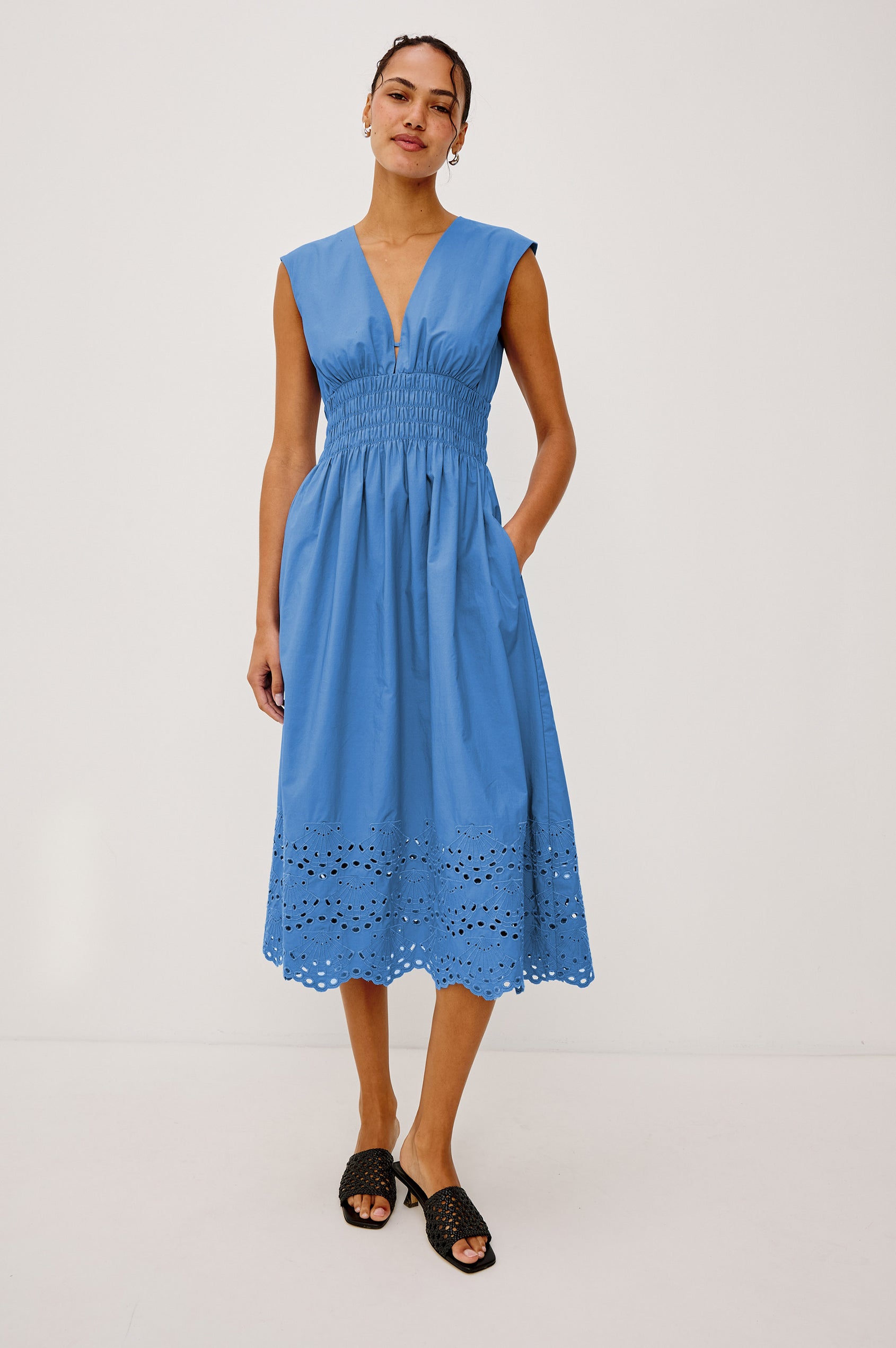 Roxanne Midi Dress in Cotton Poplin With Shirred Shoulders, Plunging V-Neck, Smocked Waist and Seashell Hem Embroidery in Harbor Blue Colorway - Full Body Front View Featured on Model