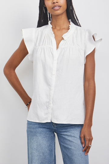 Ruthie Top with Flutter Cap Sleeves, a Ruffled Banded Collar, Buttons Down the Front, and Soft Shirring at Front Yoke in White Colorway - Front  View Featured on Model