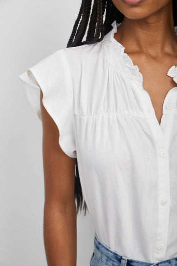 Ruthie Top with Flutter Cap Sleeves, a Ruffled Banded Collar, Buttons Down the Front, and Soft Shirring at Front Yoke in White Colorway - Front Tucked View Featured on Model