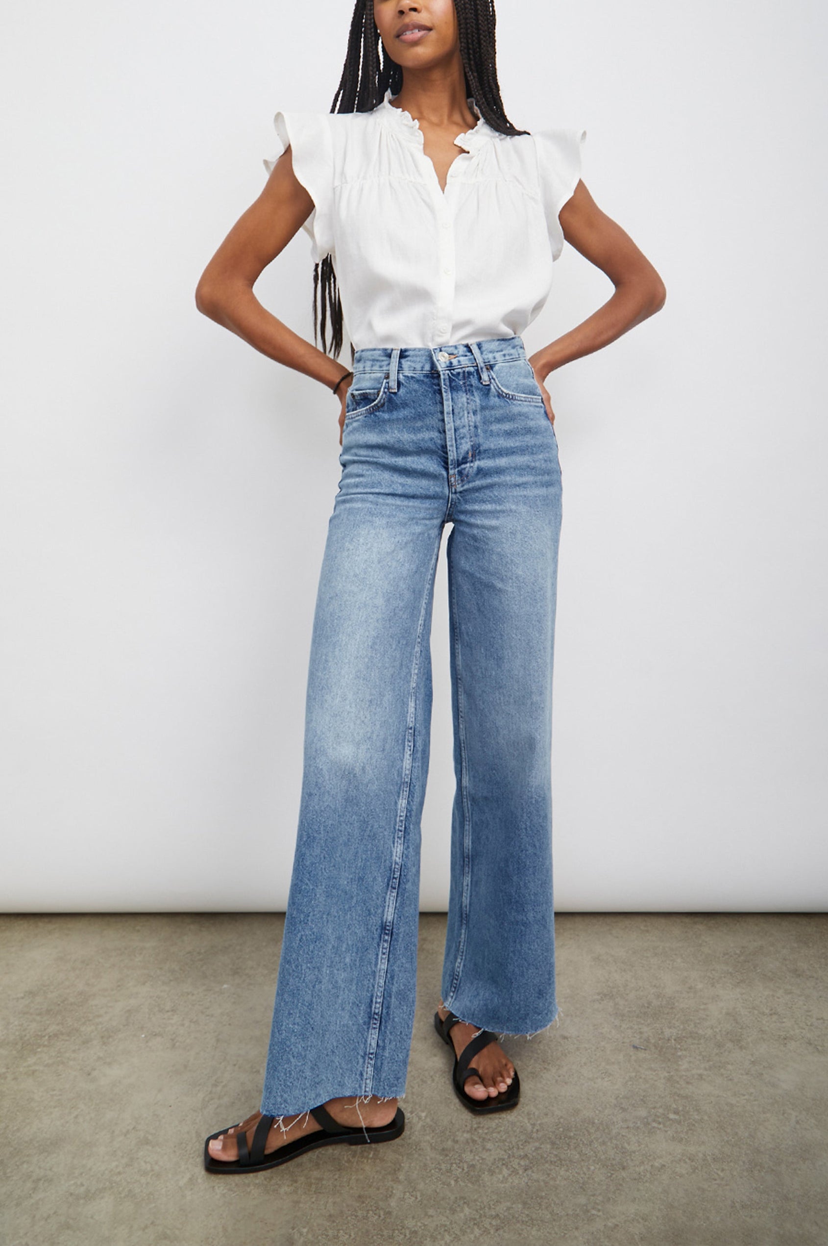 Ruthie Top with Flutter Cap Sleeves, a Ruffled Banded Collar, Buttons Down the Front, and Soft Shirring at Front Yoke in White Colorway - Front Tucked Full Body View Featured on Model