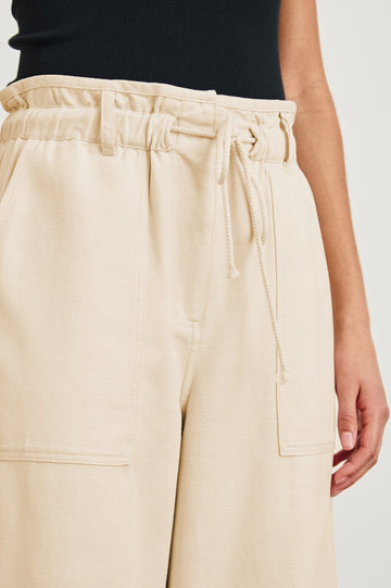 Ryan high rise linen pant with shirred waist and drawstring in Ecru - close up of details on model