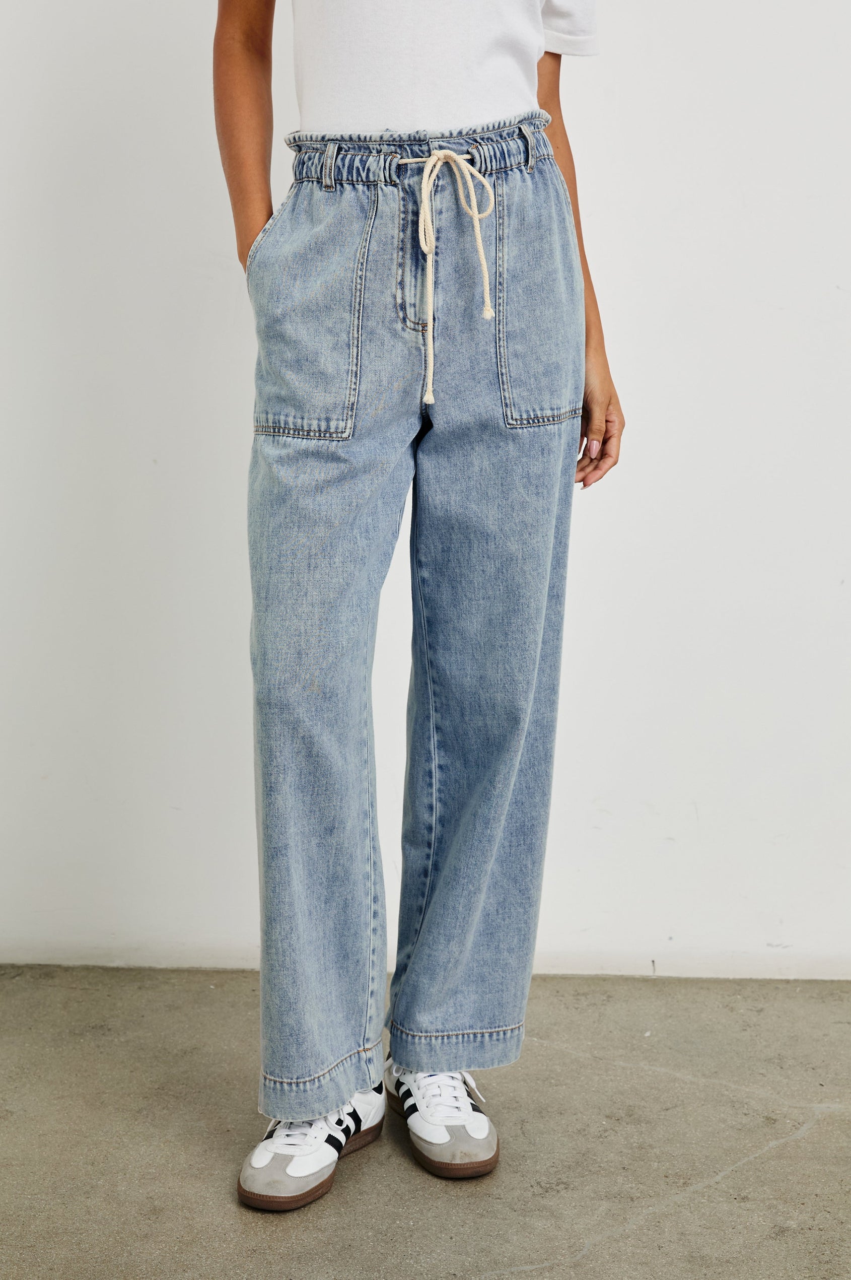 Ryan Pants with a Corded Drawstring Waist, Large Front Pockets and two Back Pockets in Faded Indigo Colorway - Front View Featured on Model