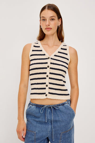 The Sade is a button front sweater vest with a v-neck in Ivory Navy Stripe colorway. Front view featured on model. 