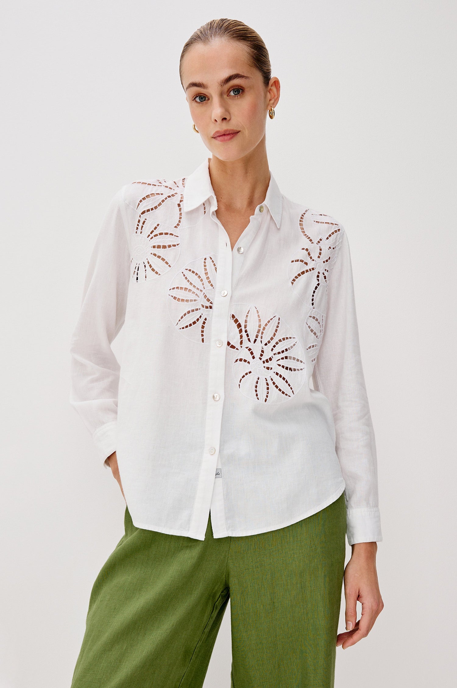 Samar Collared Button Front Top with Long Sleeves and Cutout Flower Details in White Colorway. Front View Shown on Model.