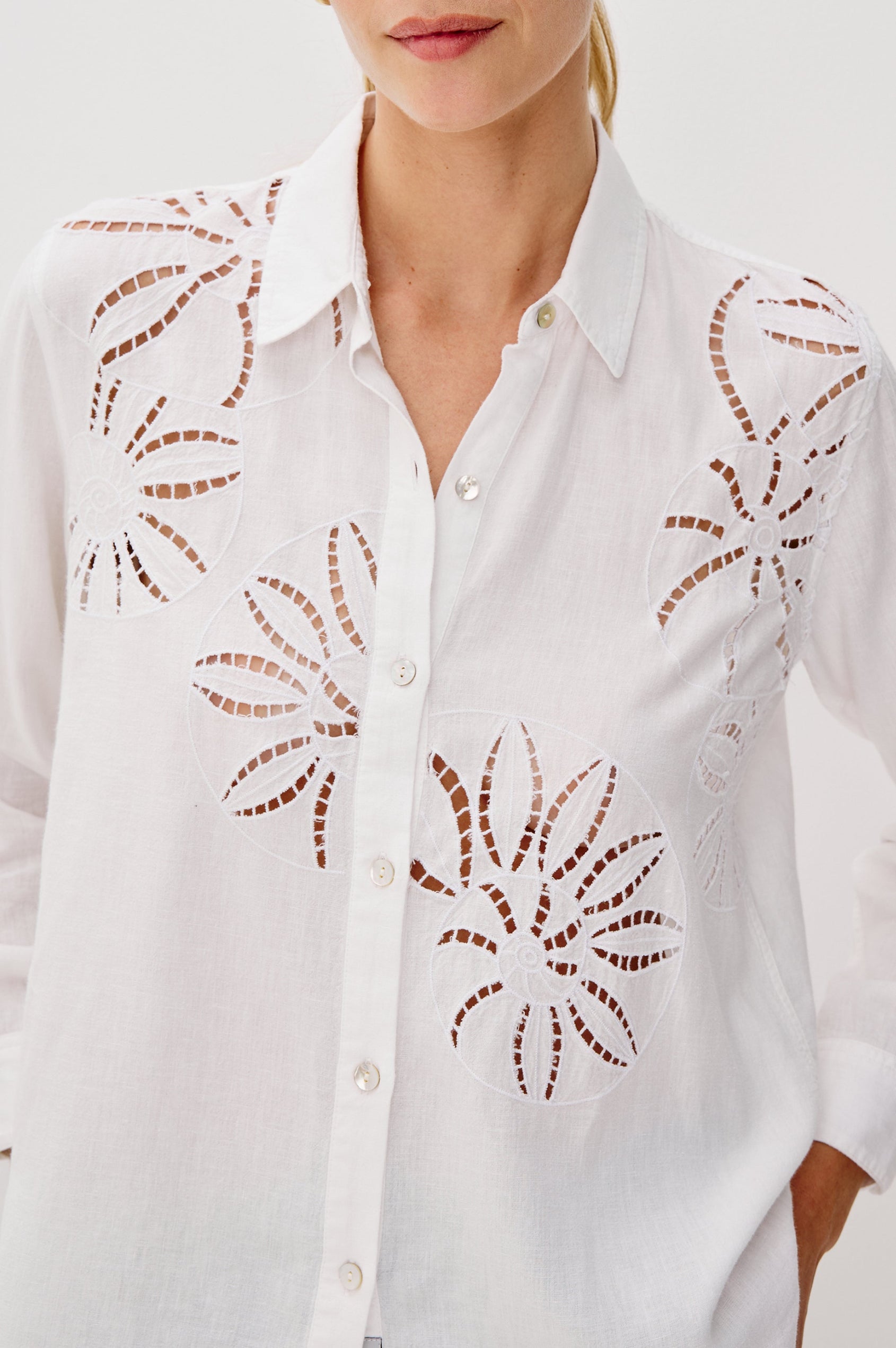 Samar Collared Button Front Top with Long Sleeves and Cutout Flower Details in White Colorway. Front Detail View Shown on Model.