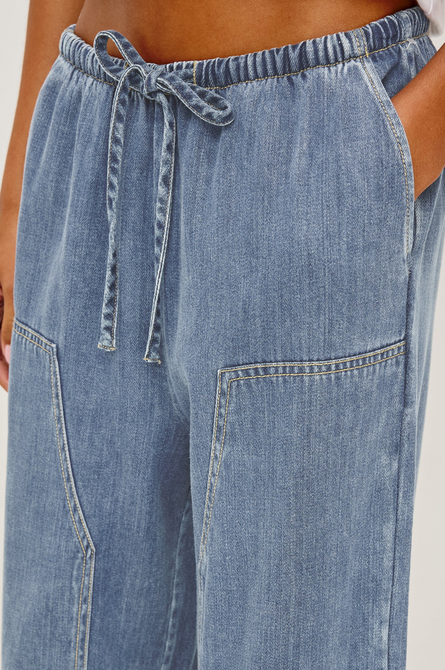Sanderson Pant in Cotton Lyocell Denim With Relaxed Fit, Drawstring Waist Tie, Side Pockets, and Carpenter-Style Leg Panels in Antique Blue Colorway - Lower Body Close Up Front View Featured on Model