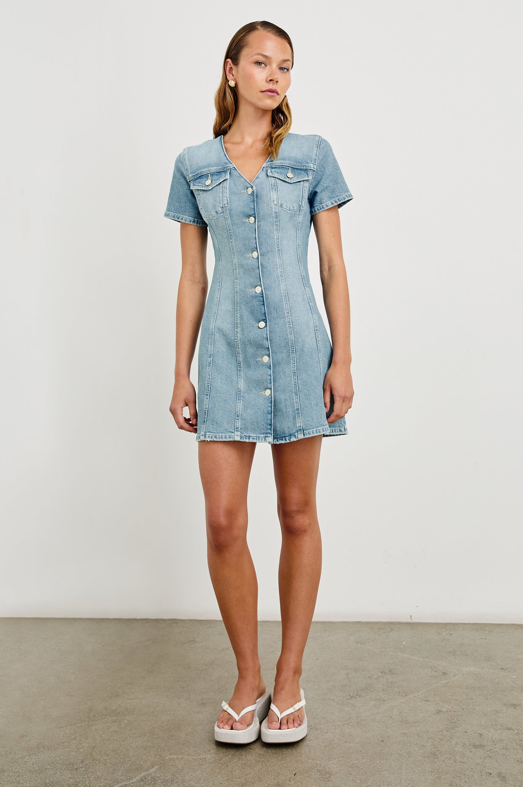 Saratoga a-line mini button down denim dress with two front chest pockets. Short sleeve and form fitting in Faded Seaglass - full body front view on model