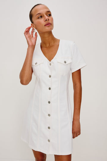 Saratoga Mini Denim Dress with a V-Neck, Short Sleeves, Button Front, Chest Flap Pockets in Salt White Colorway. Front View Shown on Model.
