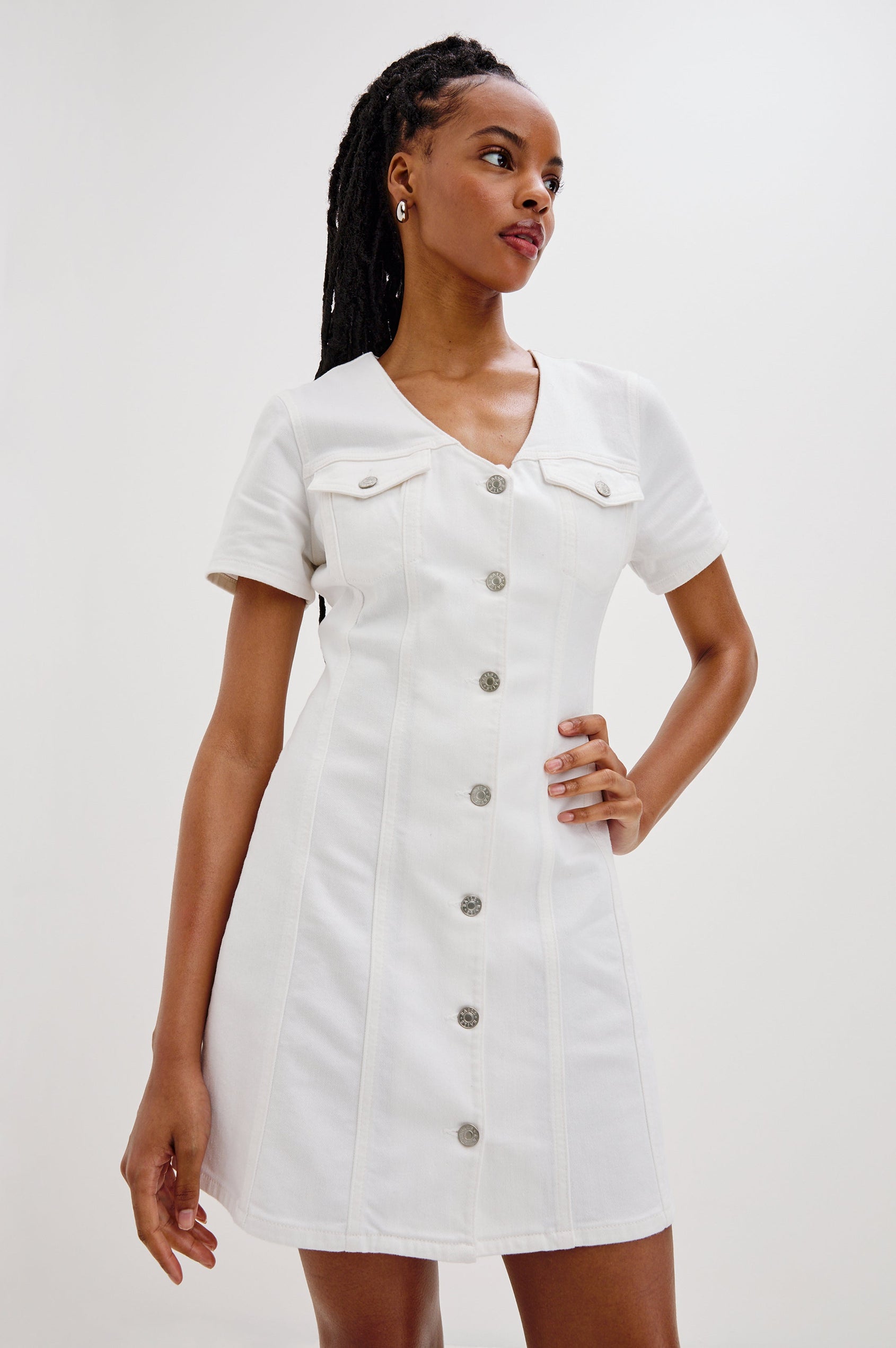 Saratoga Mini Denim Dress with a V-Neck, Short Sleeves, Button Front, Chest Flap Pockets in Salt White Colorway. Front View Shown on Model.