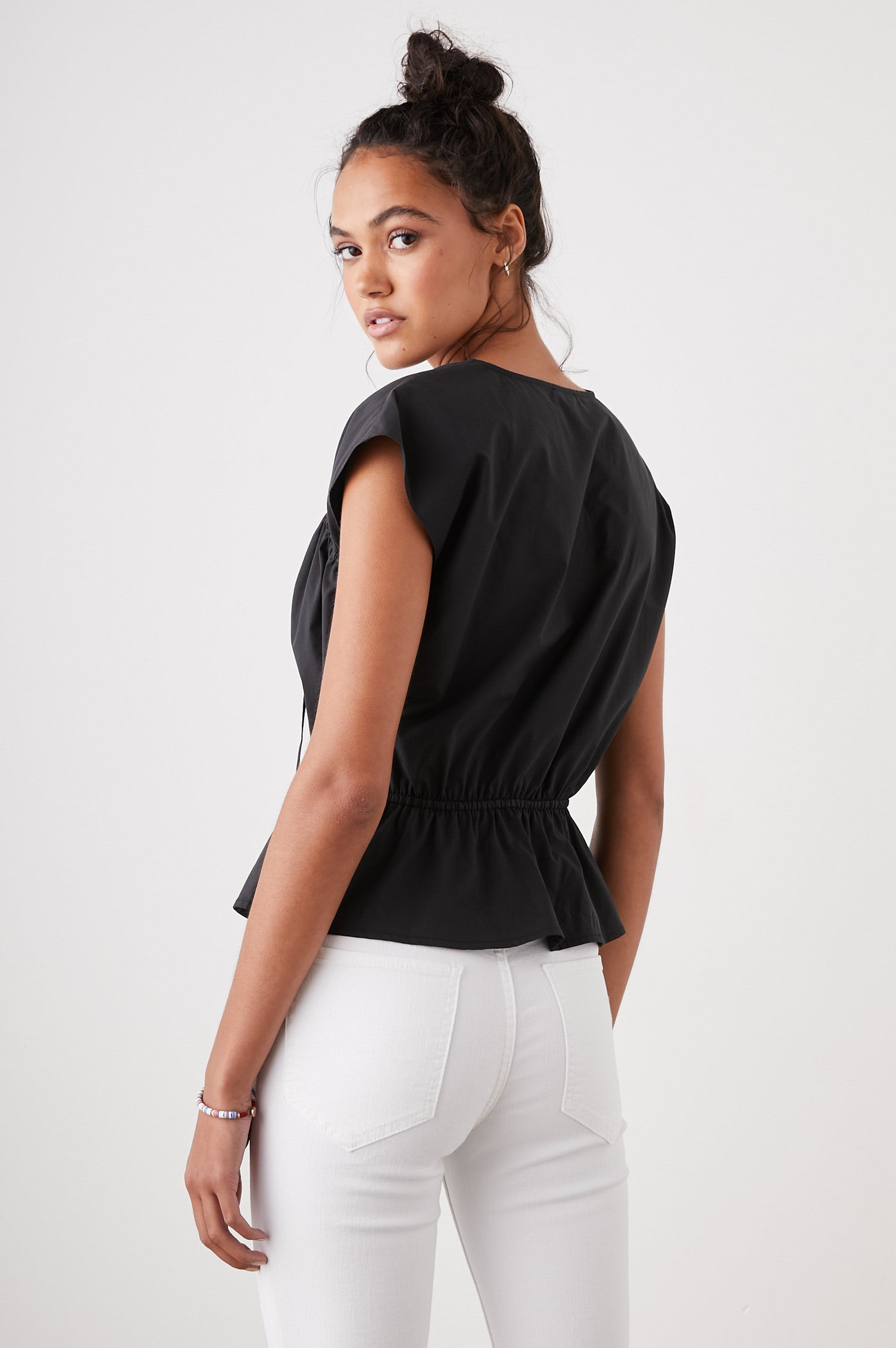 Savi Short-Sleeve Top with a V Neck, Cap Sleeves, a Drawstring From Each Sleeve Shoulder to the Neckline and a Drawstring at the Waist in Black Colorway - Back View Featured on Model 
