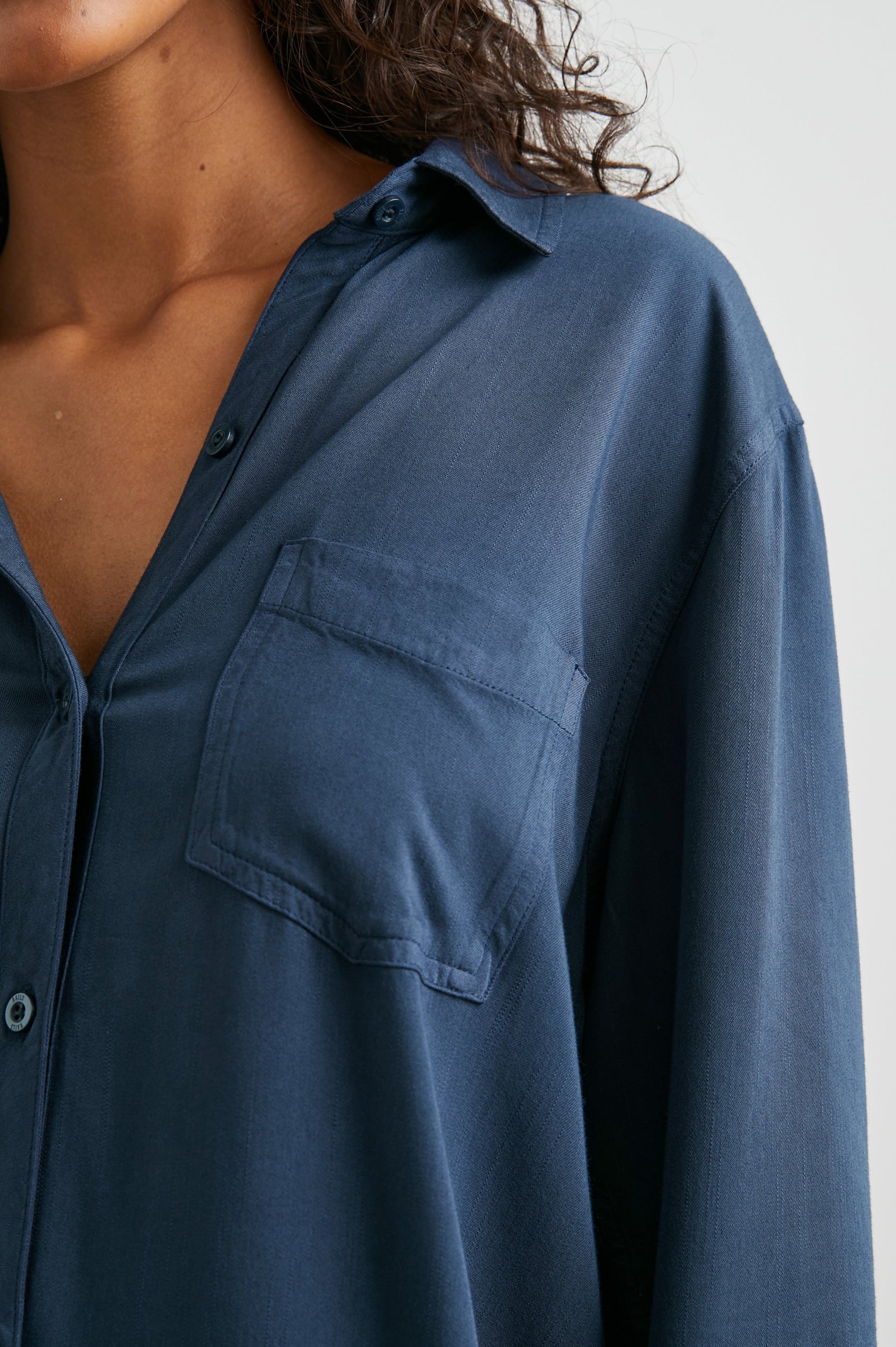 Sawyer Long-Sleeve Mini Dress with a Full Button Front, a Chest Patch Pocket, a Collar, Button Cuffs and a Low High Hem in Navy Colorway - Front View Featured on Model 