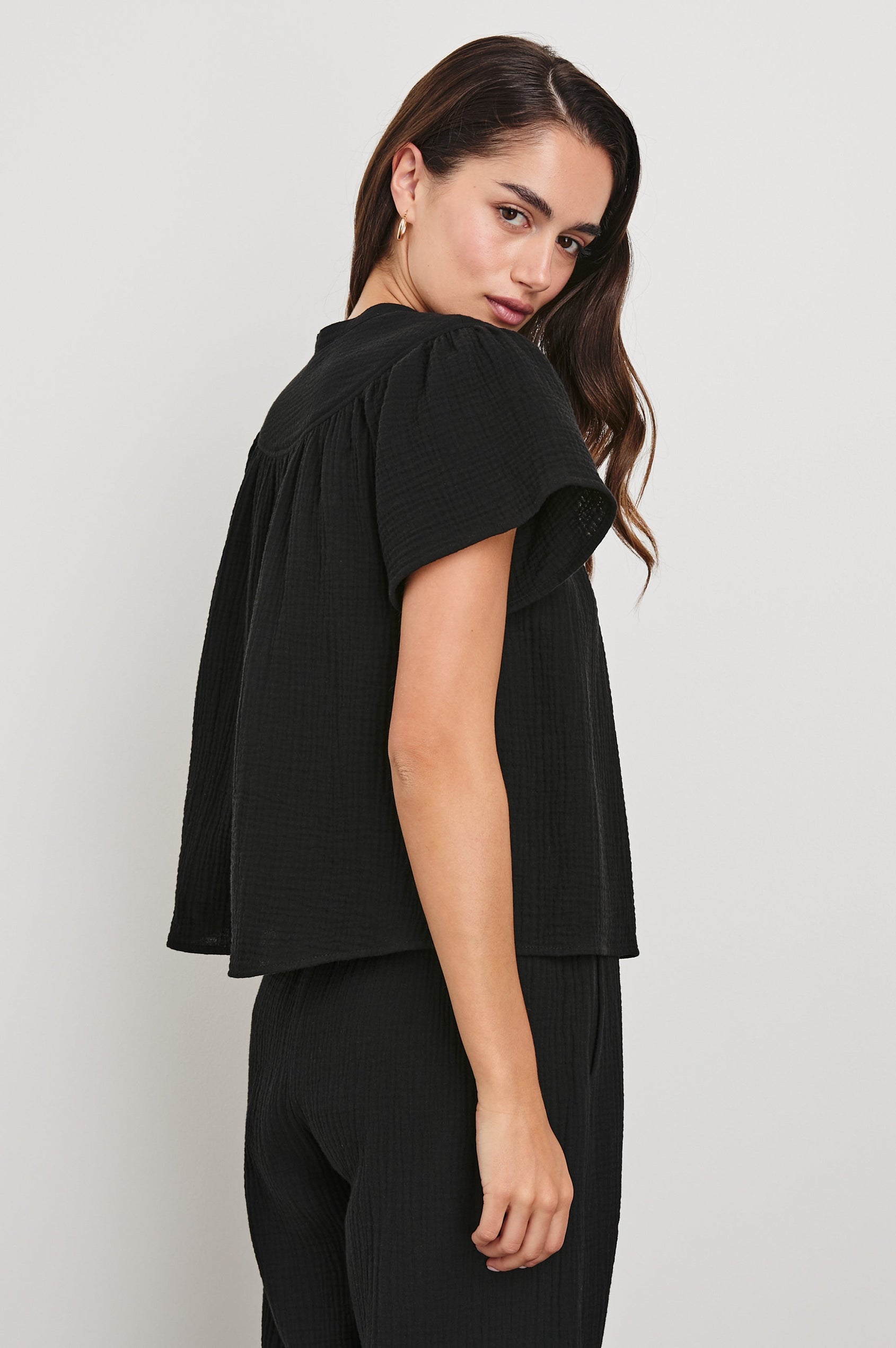 Sayer Short Sleeve Cotton Gauze Top With V-Neck In Colorway Black - Side View Featured On Model 