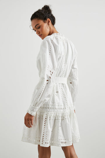 Saylor Long-Sleeve Midi Dress with a Half-Sealed Placket, a V Neck, Ruffled Collar with Shirring, a Fabric Tie Belt, and Floral and Geometric Eyelet Details in White Colorway - Back View Featured on Model 