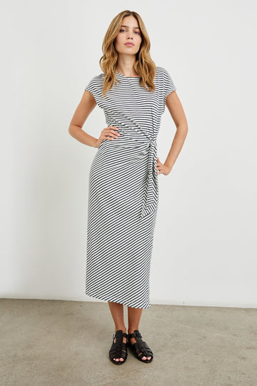 Selah Maxi Dress with Short Sleeves, Boatneck, Adjustable Side Tie at Waist and Two Mid-Calf Side Slits in Black Colorway  - Front Full Body View Featured on Model