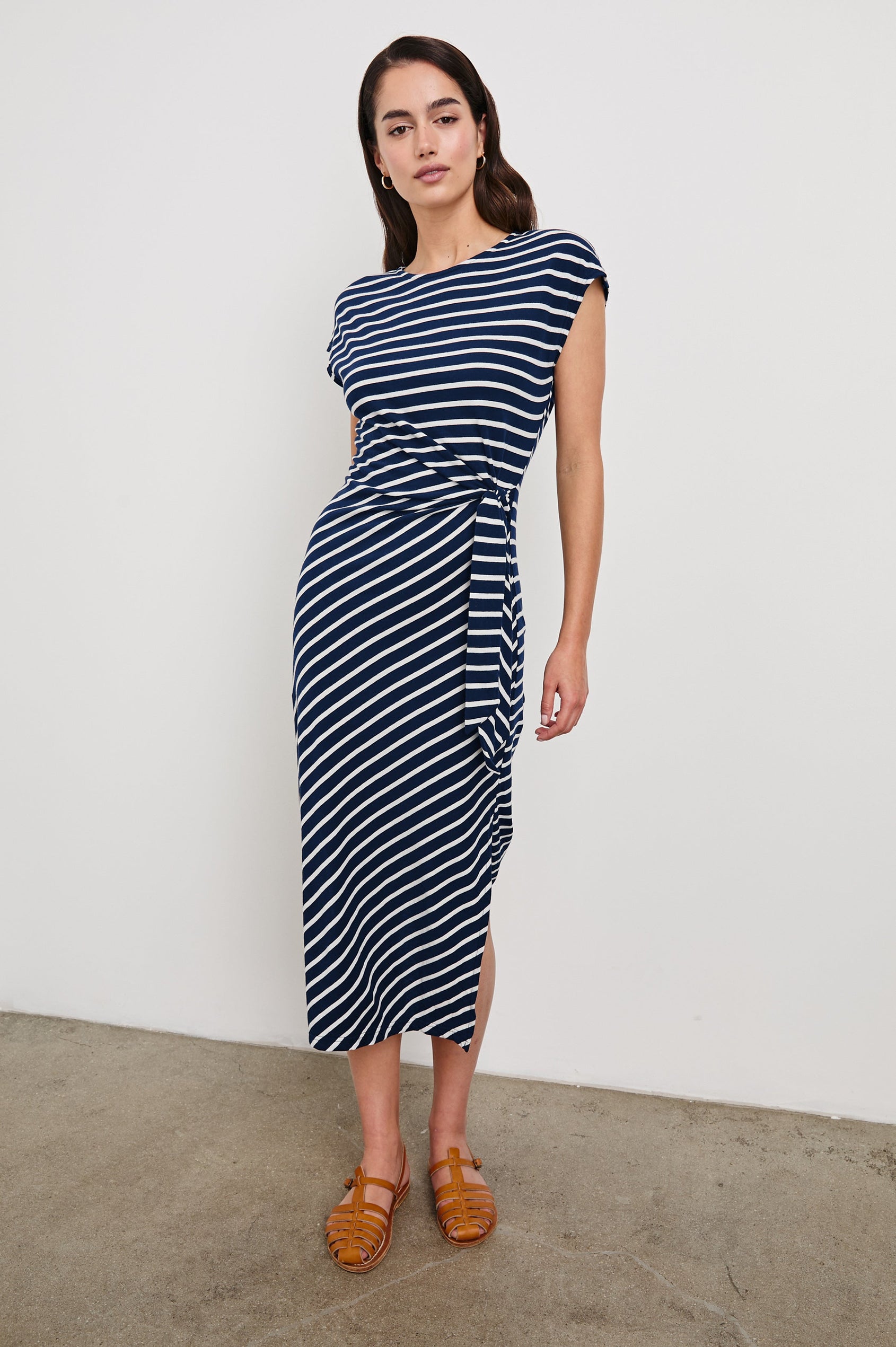 Selah Short Sleeve Jersey Dress With Side Tie In Colorway Navy Ivory Stripe -  Full Front Body View Featured On Model In Motion