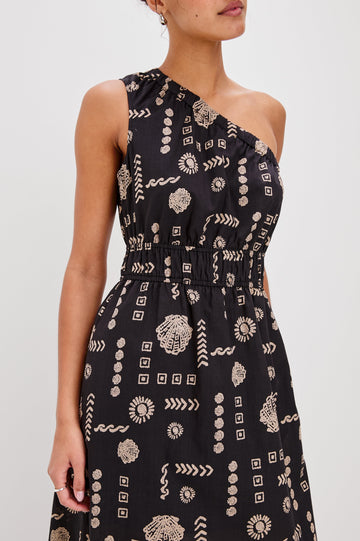 Selani Below-Knee One Shoulder Dress with a Side Slit and Encased Elastic Across Chest and Waist. Front Detailed View Shown on Model.