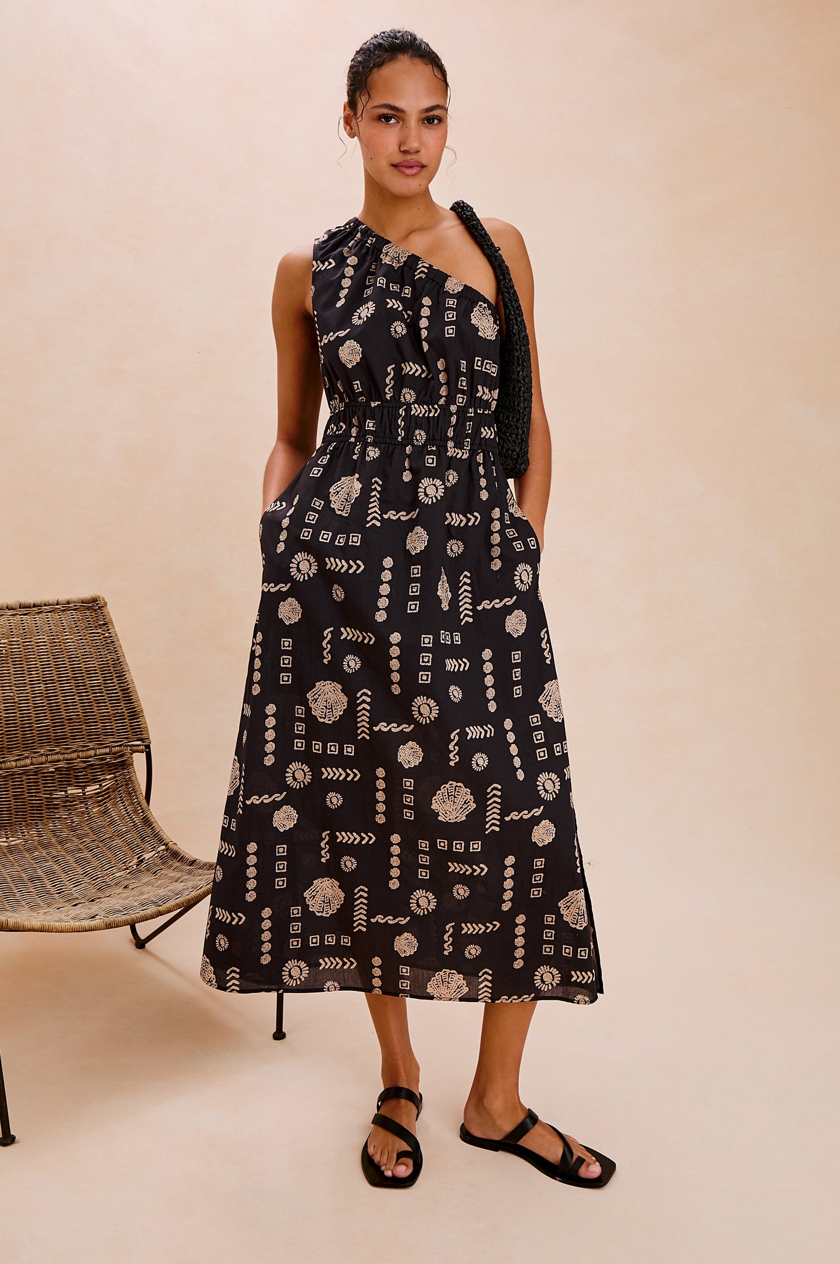 Selani Below-Knee One Shoulder Dress with a Side Slit and Encased Elastic Across Chest and Waist. Full Body Front View Shown on Model.