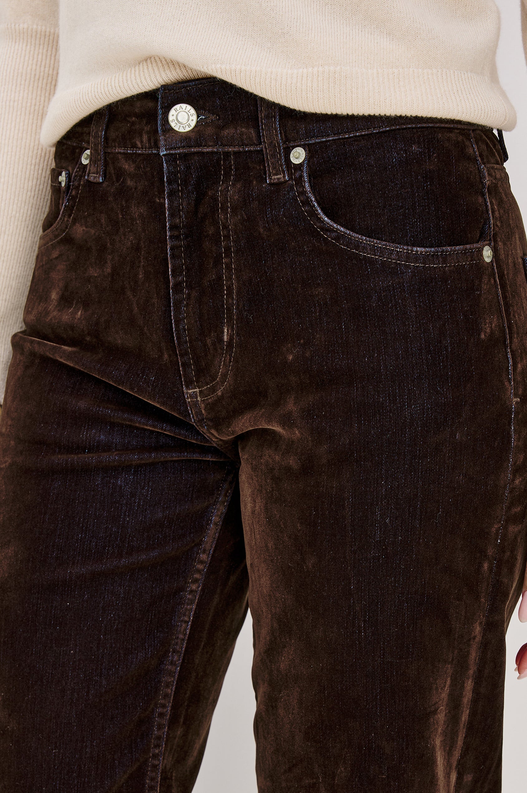 Sepulveda is a mid-rise 5-pocket, zip-front jean with a relaxed straight leg in chocolate-flocked denim in Chocolate Flocking colorway. Front detail view featured on model.