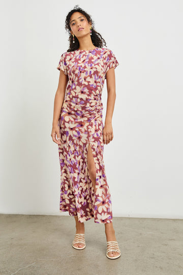 Serenity midi length crew neck dress with short sleeves, asymmetrical draping and side slit in Amaranth print - front view on model