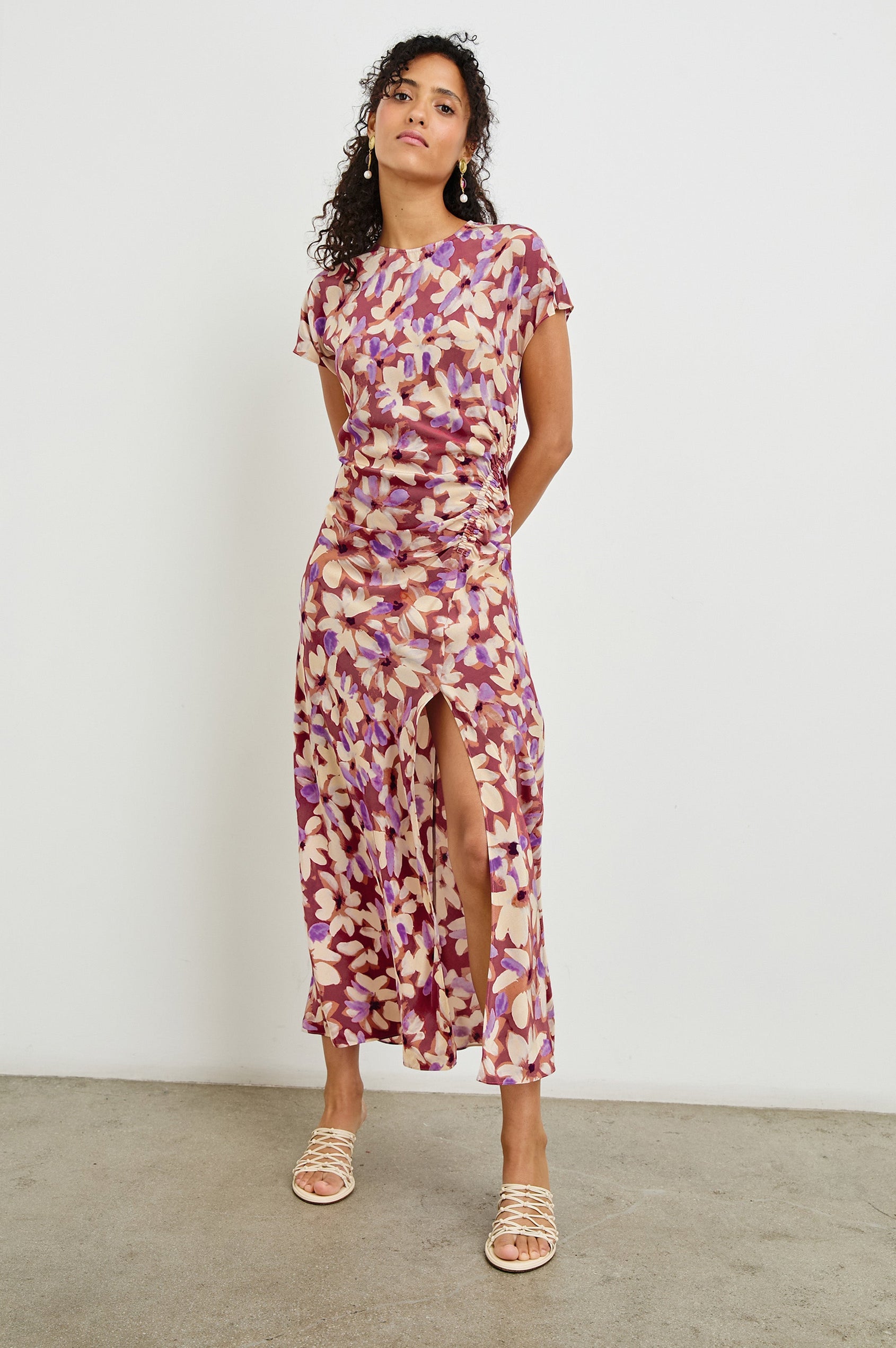 Serenity midi length crew neck dress with short sleeves, asymmetrical draping and side slit in Amaranth print - full body front view on model