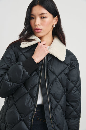 Shay Quilted Jacket with Zip Closure and a Cream Sherpa Collar in Black Colorway - Front View Featured on Model 