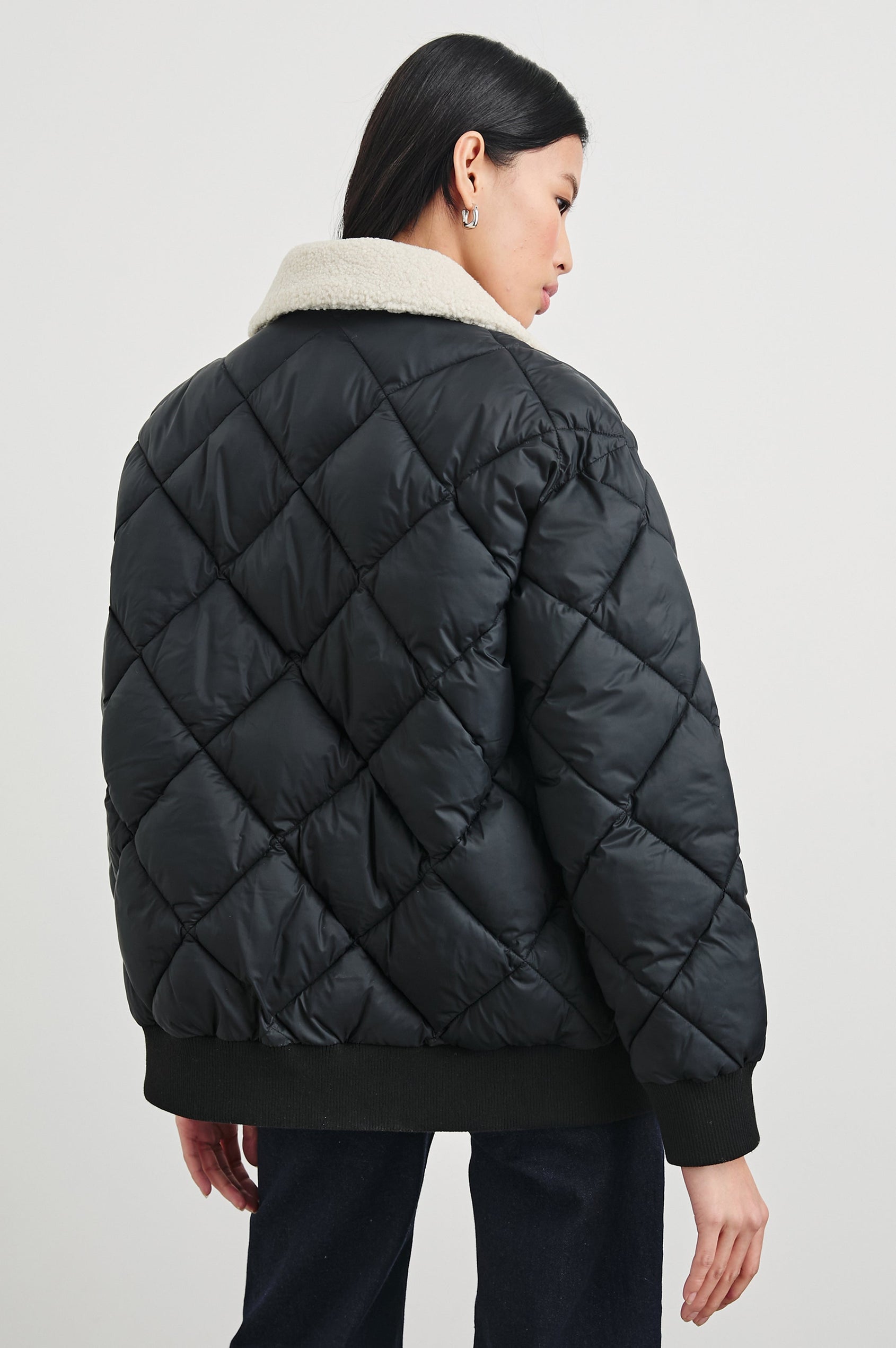 Shay Quilted Jacket with Zip Closure and a Cream Sherpa Collar in Black Colorway - Back View Featured on Model 