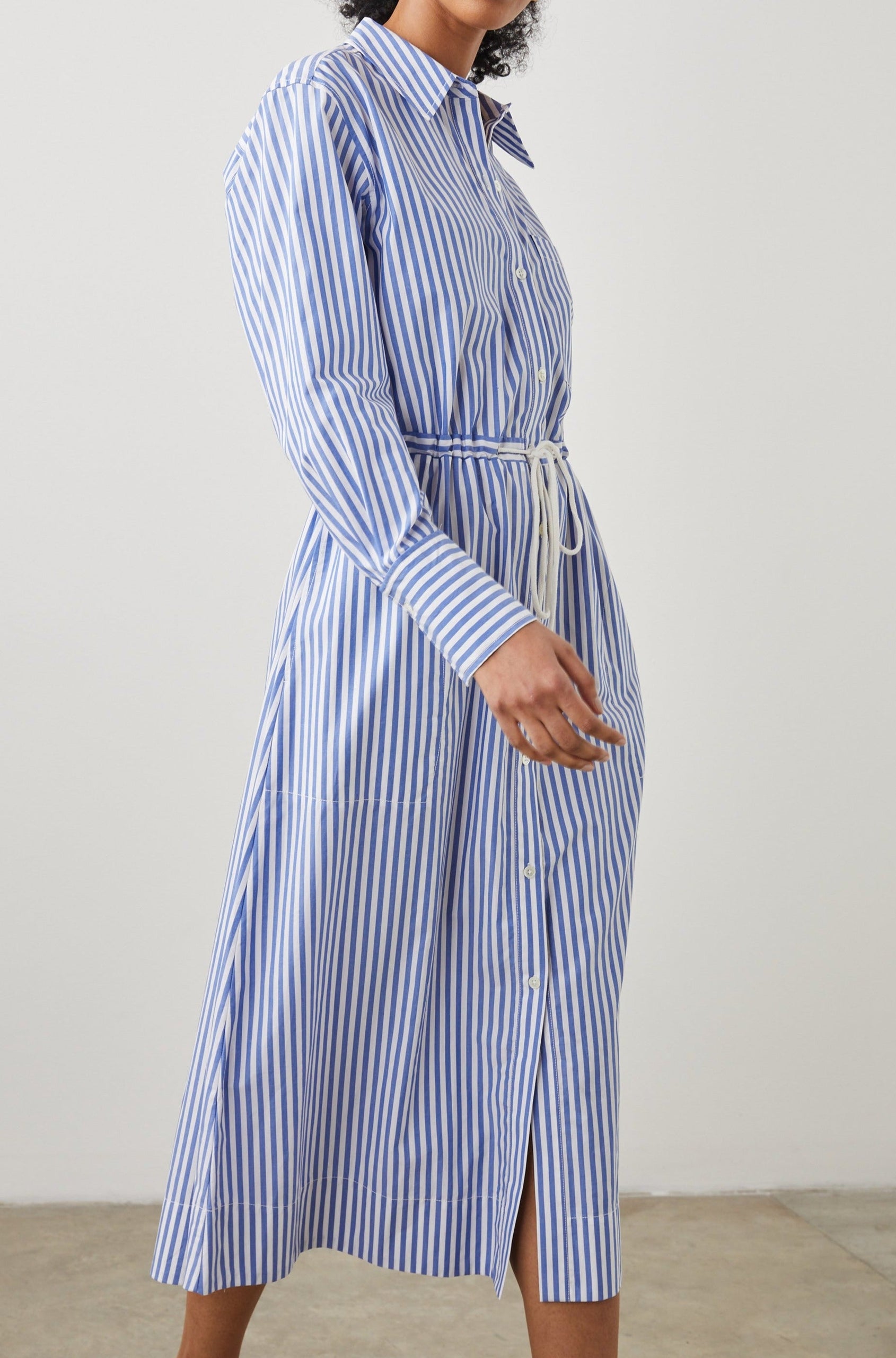 Shivonne Long-Sleeve Midi Dress with a Full Button Front, a Collar and a Drawcord Waist in Rivera Stripe Colorway, Blue and White Vertical Stripes - Side Full Body View Featured on Model