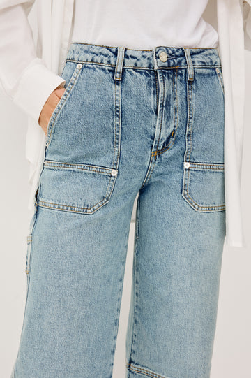 Silverado Pant in Comfort Stretch Denim With High-Waisted Fit, Wide Legs,and Utility Details and Pockets in Blueprint Colorway - Lower Body Front Close Up View Featured on Model