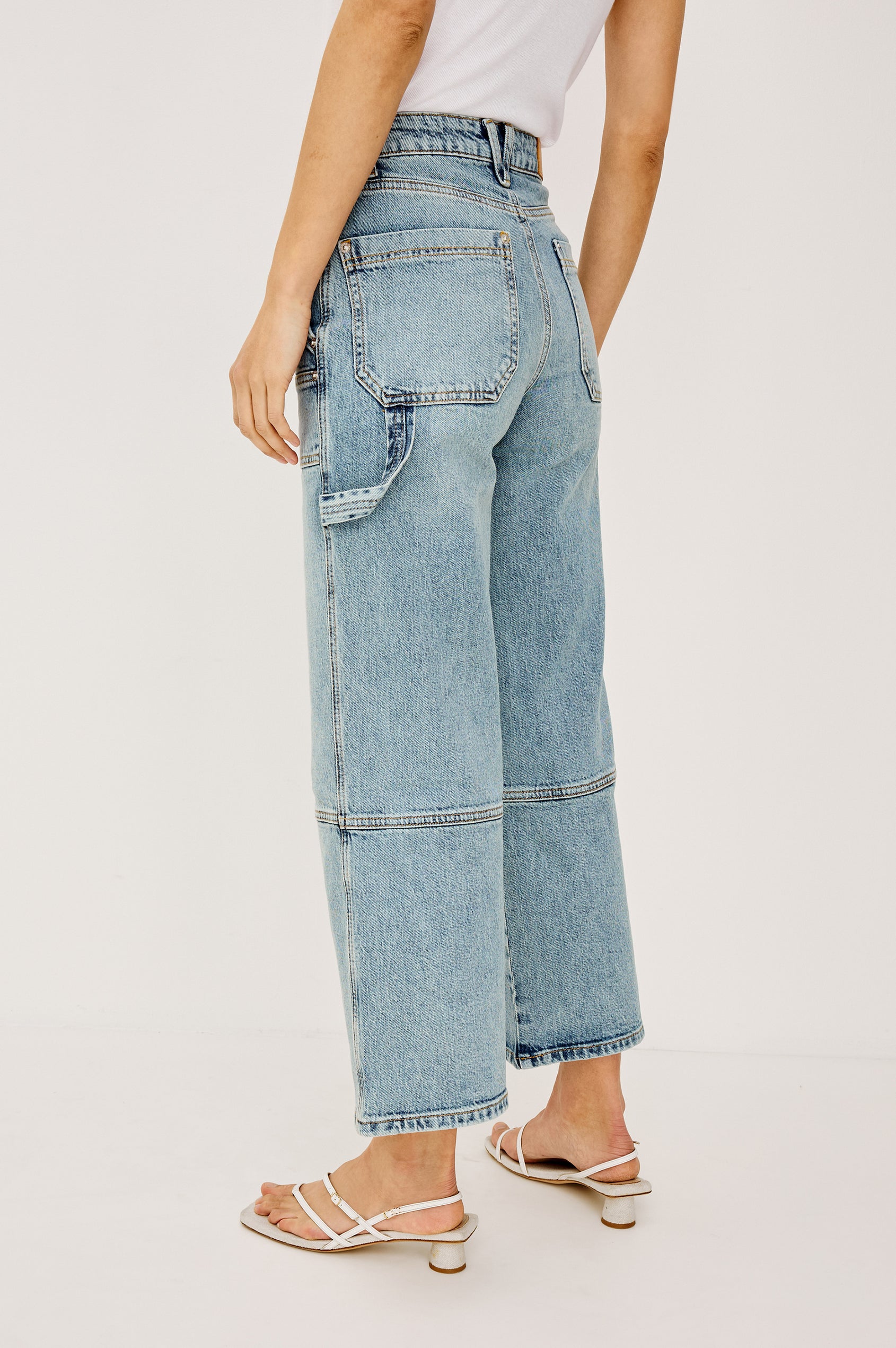 (Video): Silverado wide-leg carpenter cropped jeans in Blueprint, highlighting side utility loops and pocket details - full body view on model.