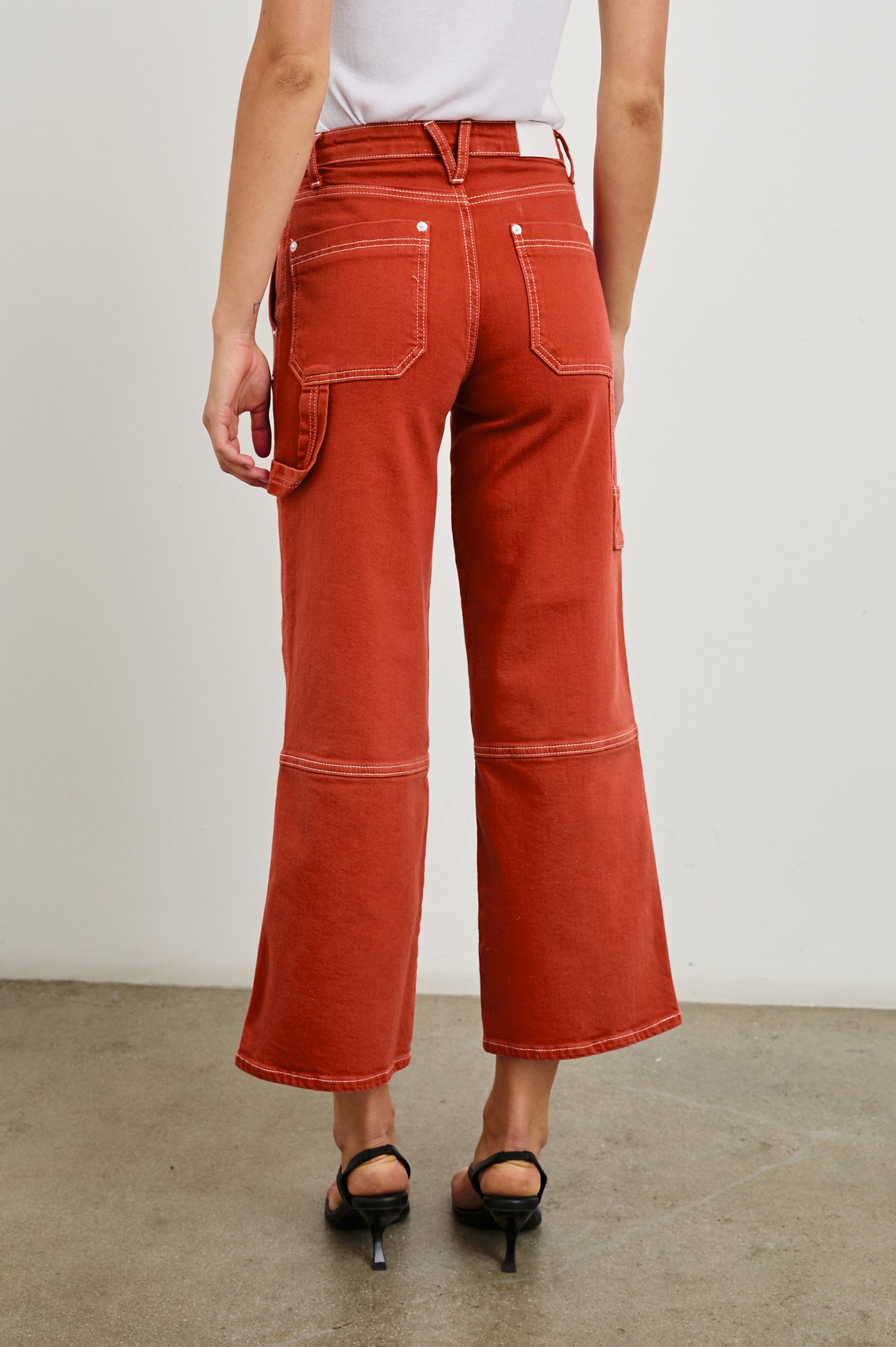 Silverado high rise wide leg crop pant with carpenter style details and contrast stitching in Terracotta - back view on model