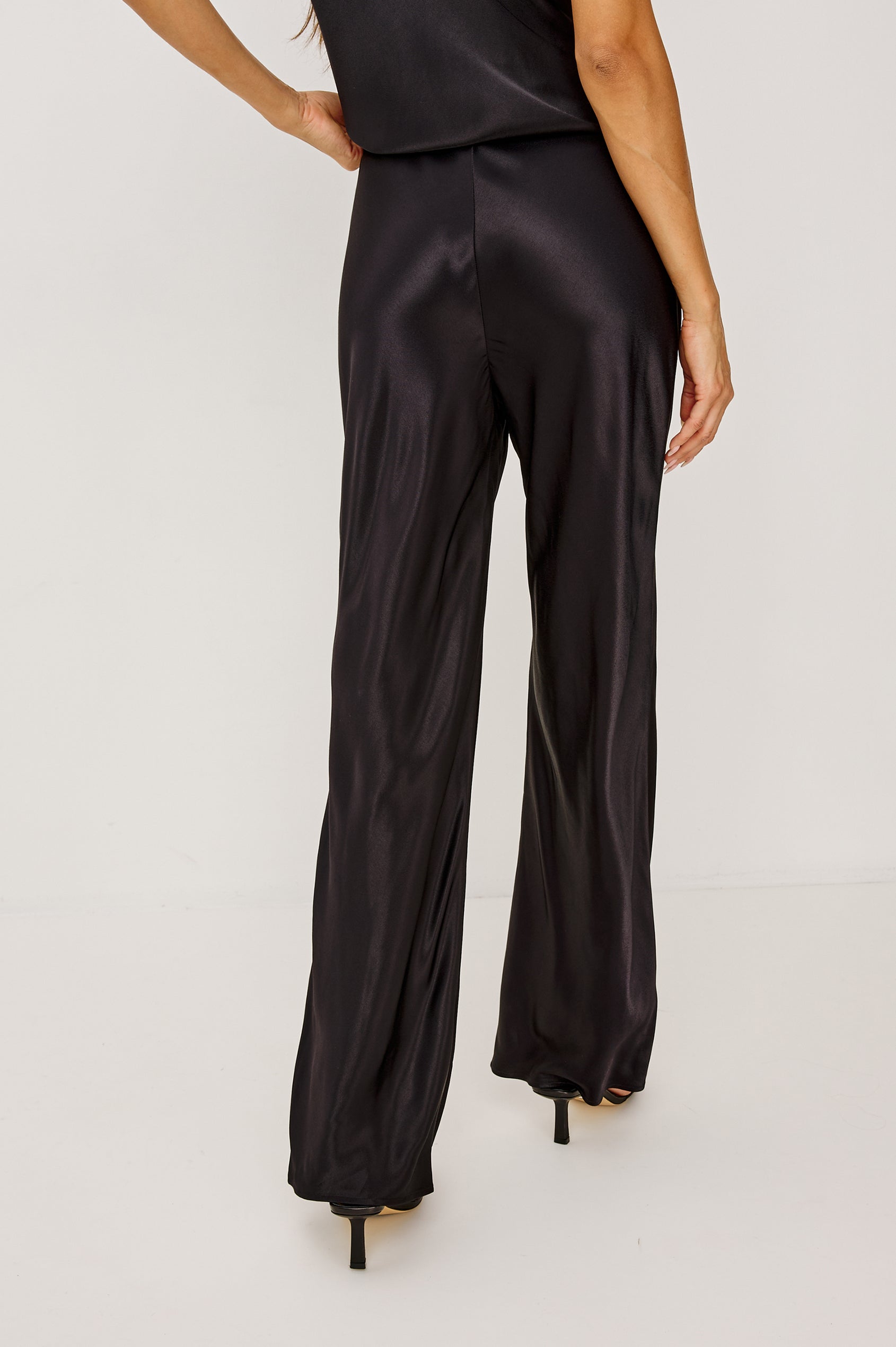 Silvi High-Waisted Pant in Metallic Satin Back Crepe With Elastic Waistband and Straight Legs in Black Colorway - Lower Body Back View Featured on Model
