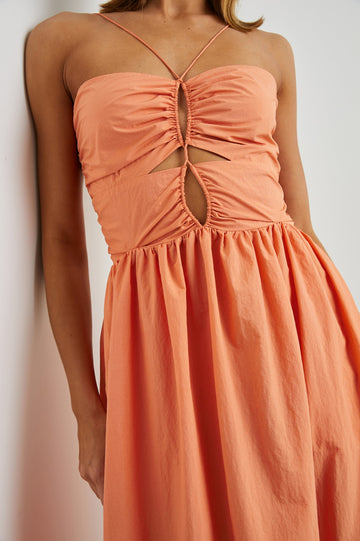Silvia Sleeveless Maxi Dress with Spaghetti Straps with a Lower Back Tie, an Open Back, and Cutouts Along the Center of the Bodice in Papaya Colorway - Front View Featured on Model