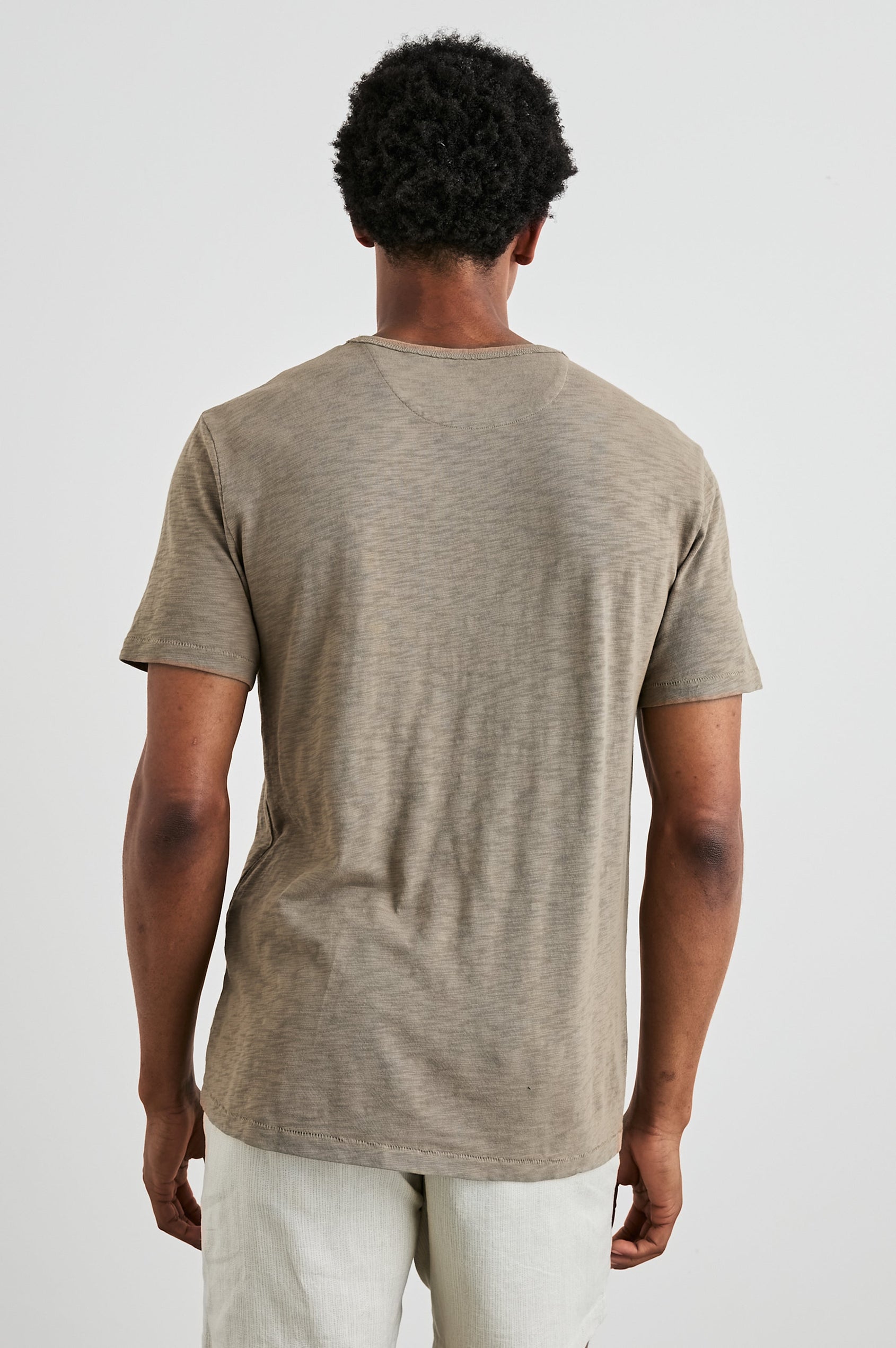 Skipper Short-Sleeve T-shirt with a Crew Neck and a Chest Patch Pocket in Barley Colorway - Back View Featured on Model