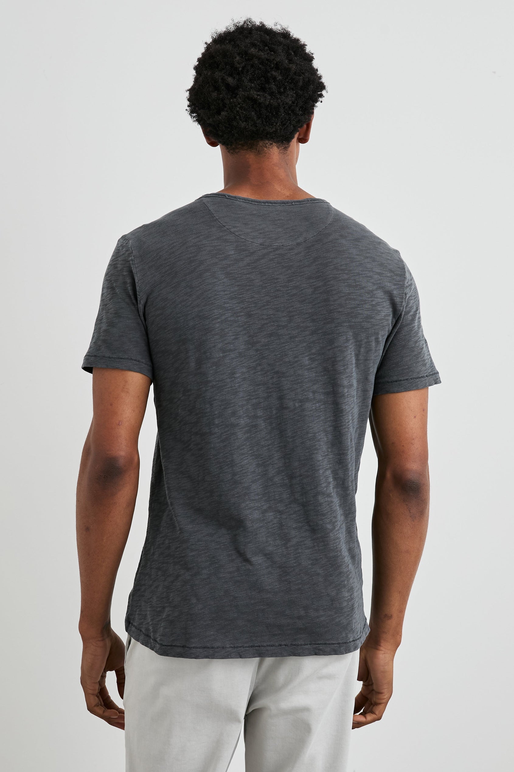 Skipper Short-Sleeve T-shirt with a Crew Neck and a Chest Patch Pocket in Faded Navy Colorway - Back View Featured on Model