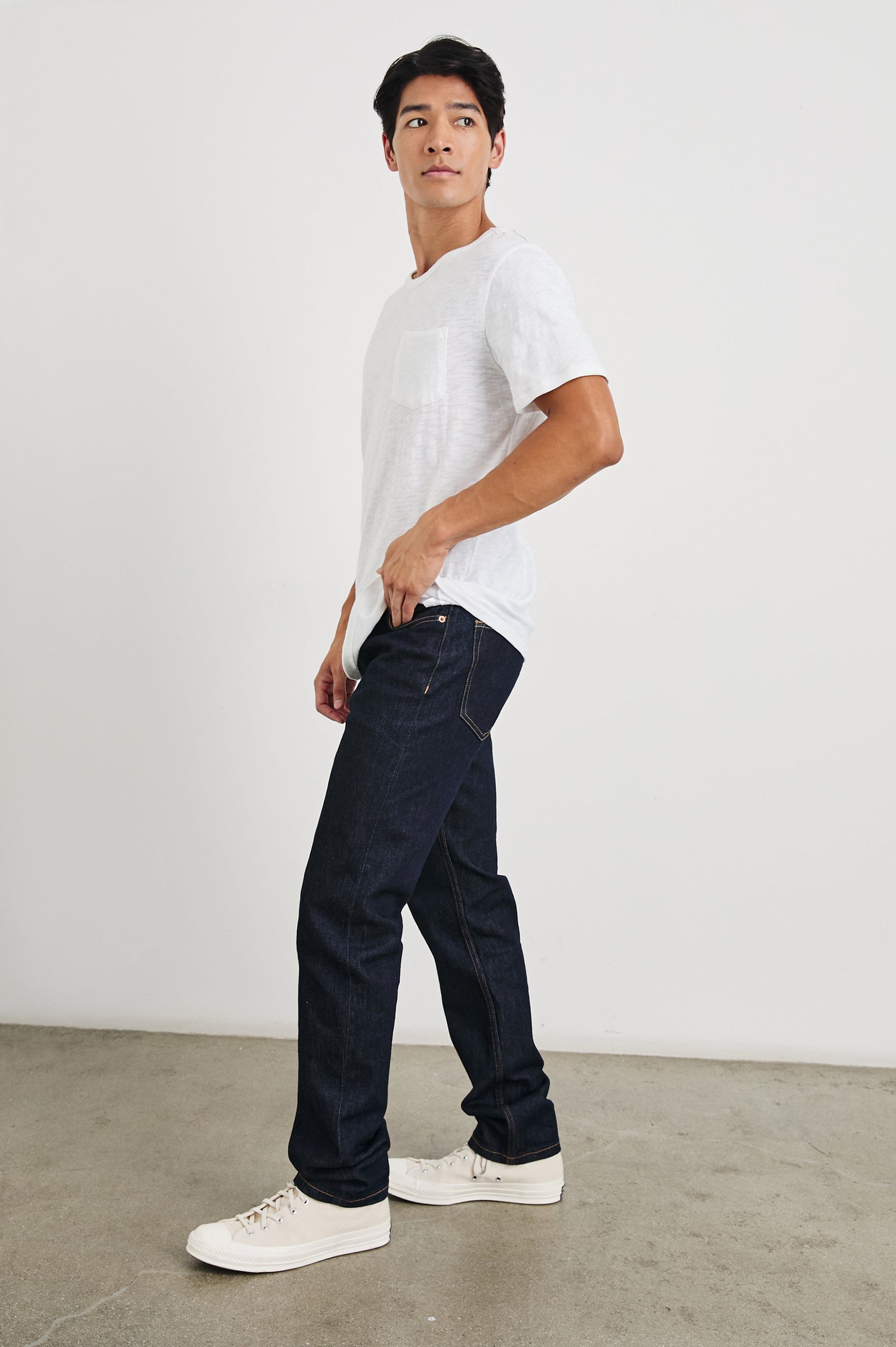 Skipper Short-Sleeve T-shirt with a Crew Neck and a Chest Patch Pocket in White Colorway - Side Full Body View Featured on Model