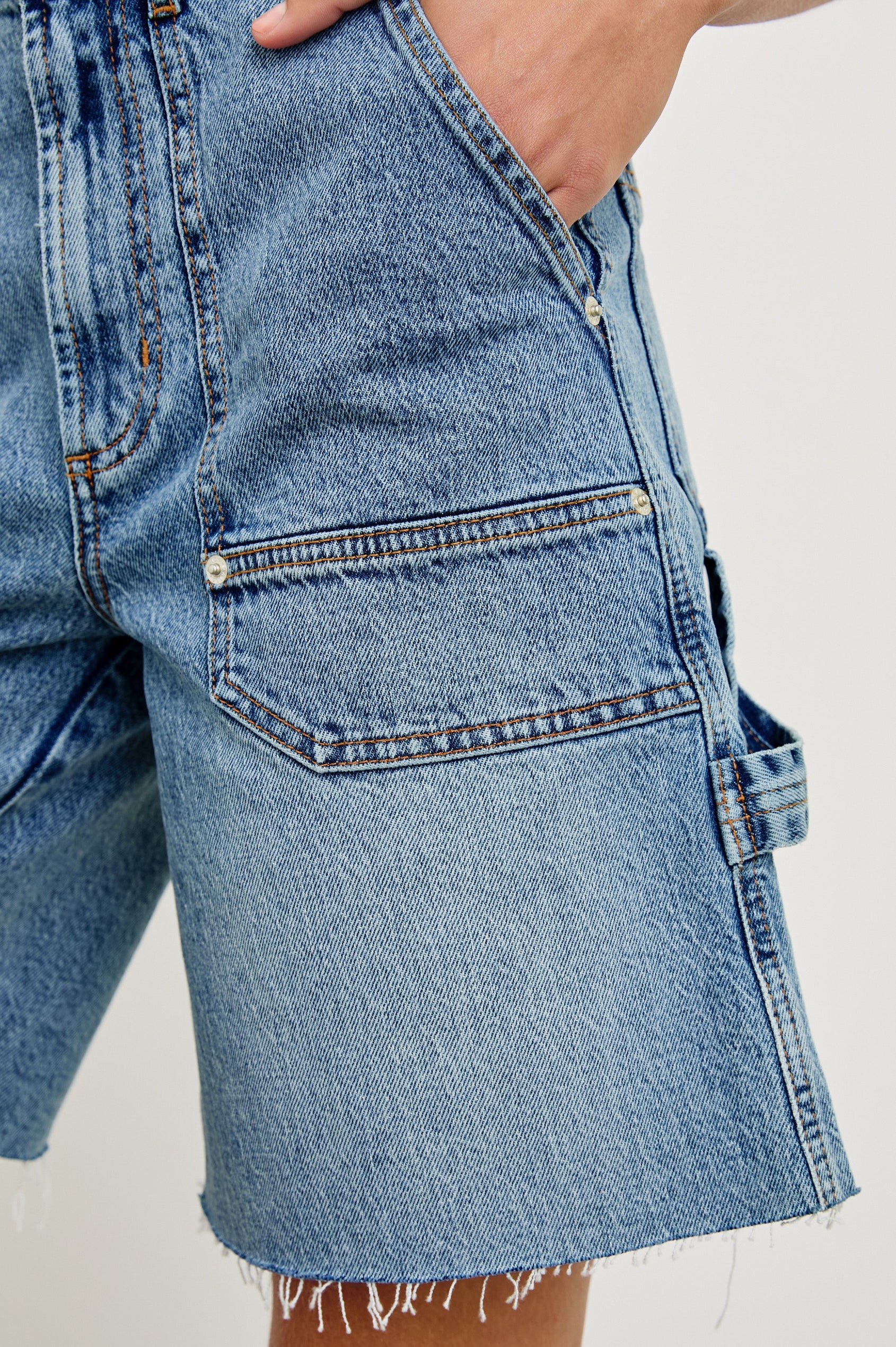 Slater high rise bermuda short with carpenter style details in Blueprint - front view on model