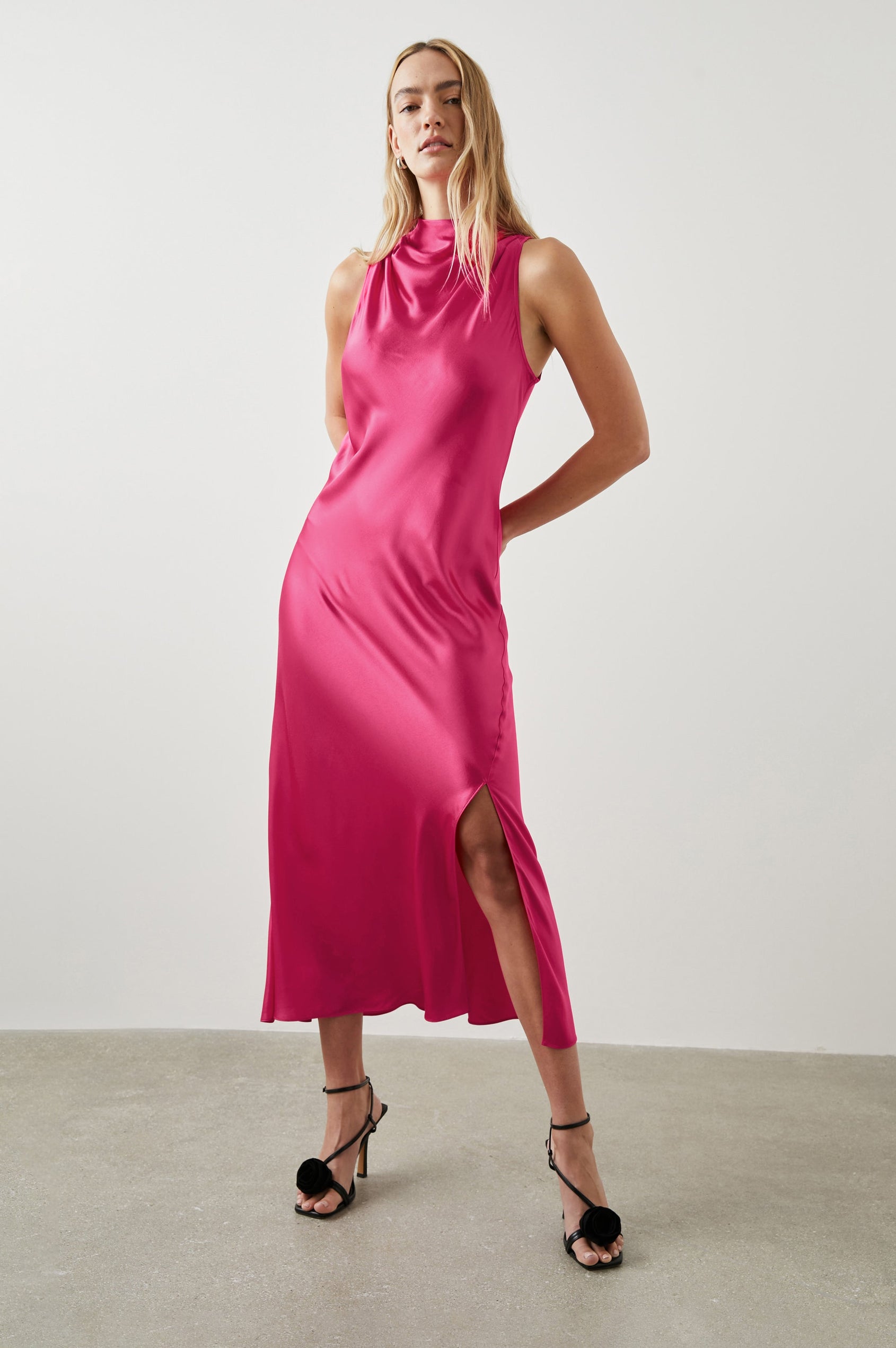 Solana Sleeveless Midi Dress with a High Cowl Collar, Side Slit, and Two Button Keyhole Closure at the Back in Magenta Colorway - Front Full Body View Featured on Model
