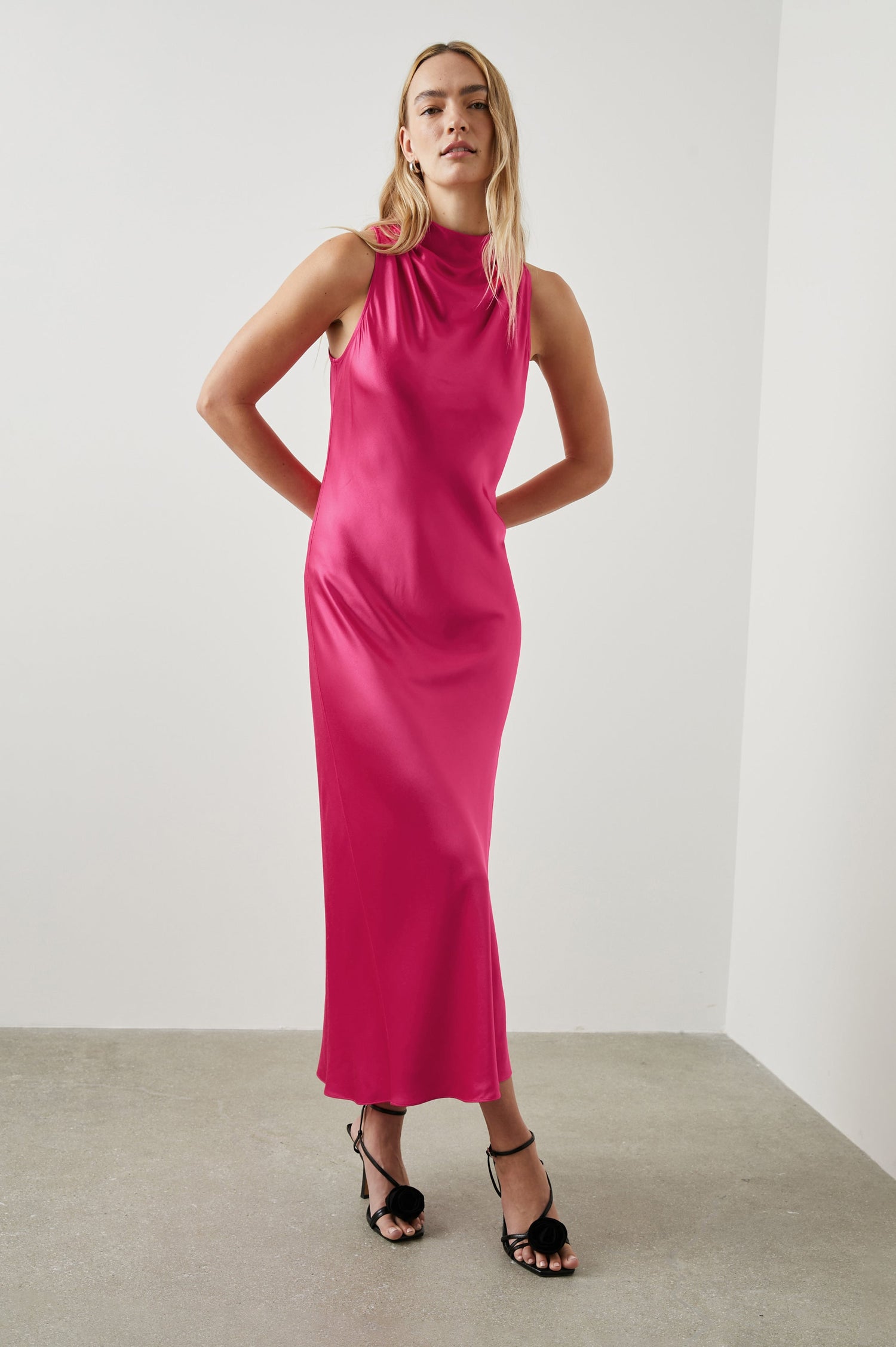 Solana Sleeveless Midi Dress with a High Cowl Collar, Side Slit, and Two Button Keyhole Closure at the Back in Magenta Colorway - Front Full Body View Featured on Model