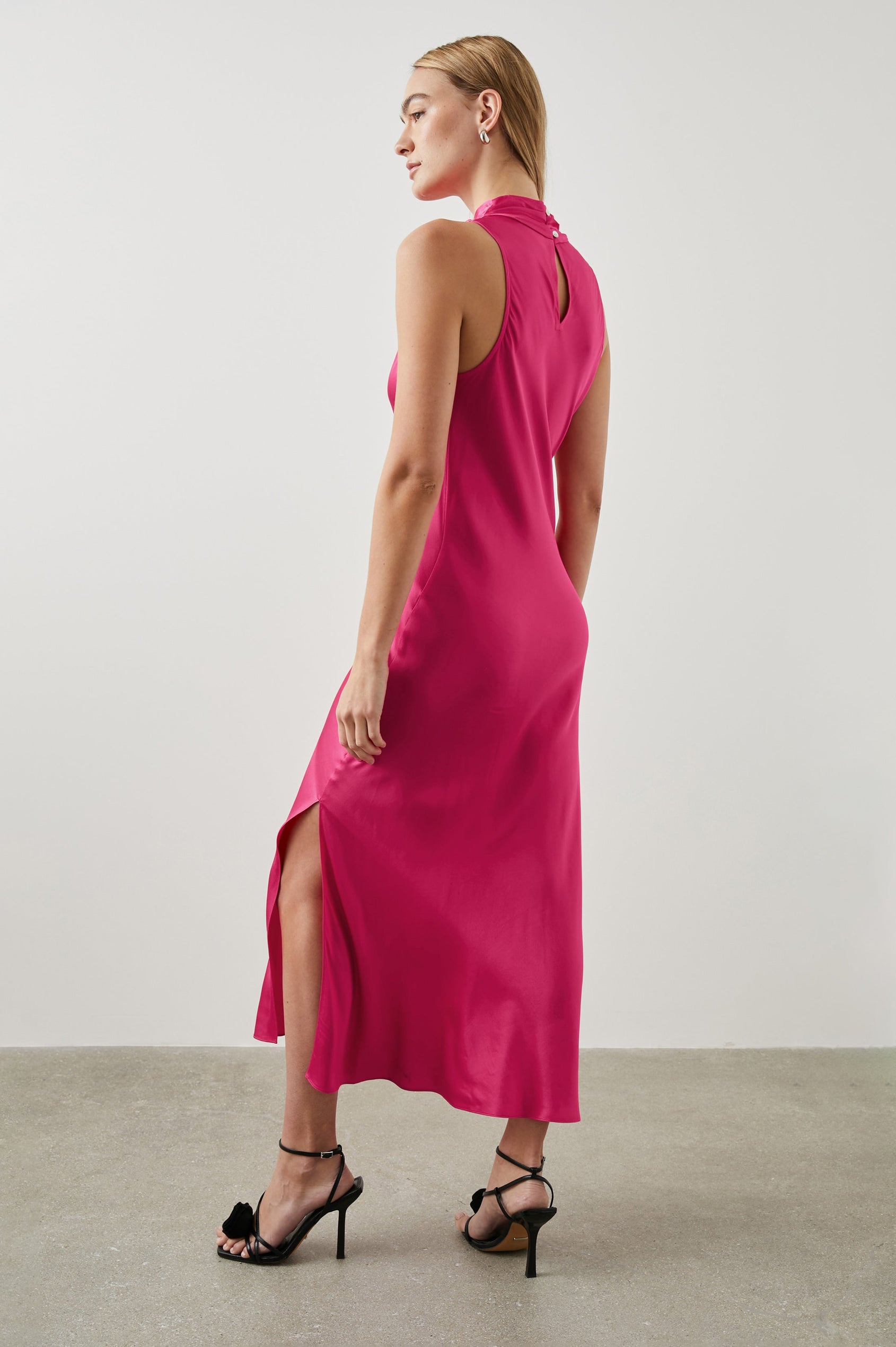 Solana Sleeveless Midi Dress with a High Cowl Collar, Side Slit, and Two Button Keyhole Closure at the Back in Magenta Colorway - Back Full Body View Featured on Model