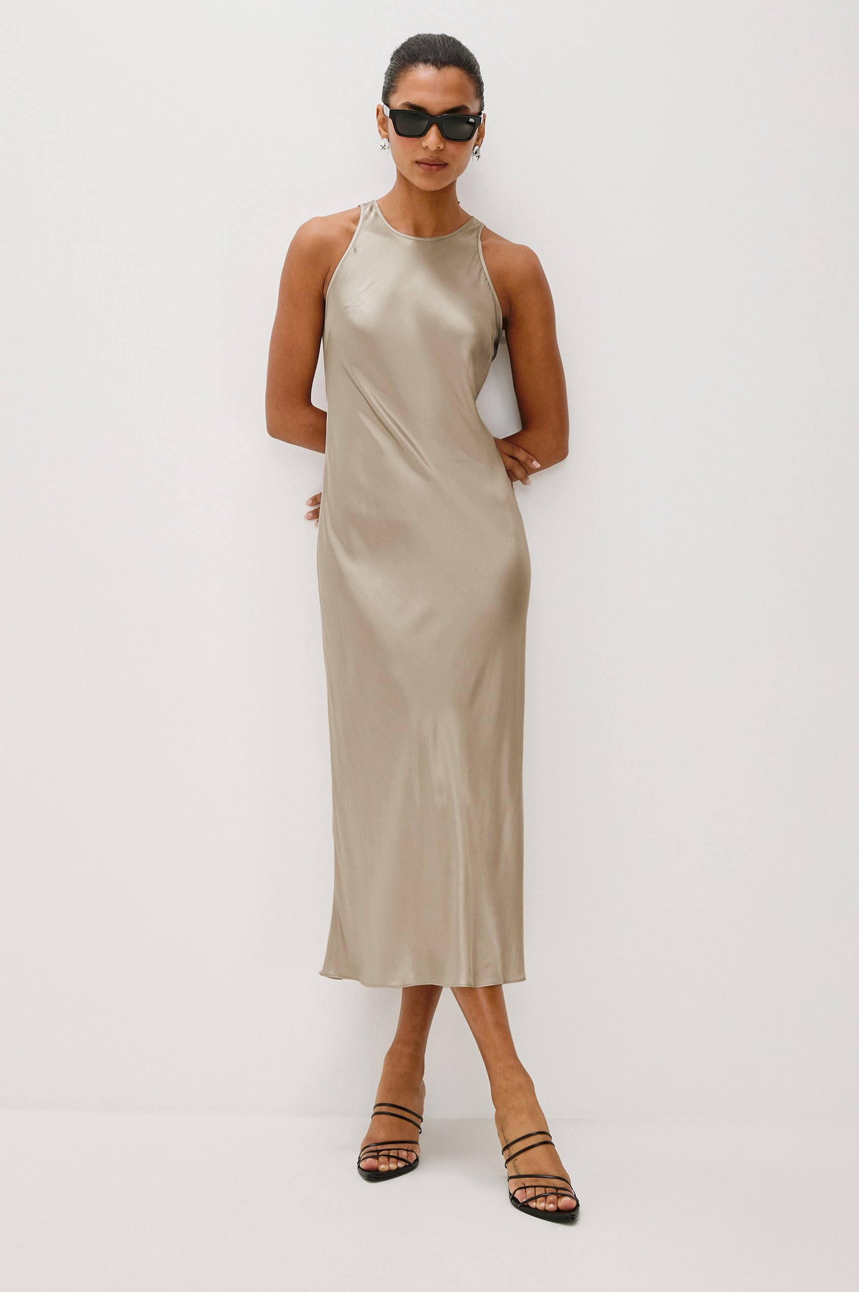 Solene Sleeveless Midi Dress with a Crew Neck and a Tie Keyhole at the Back in Mink Colorway - Front Full Body View Featured on Model wearing sunglasses