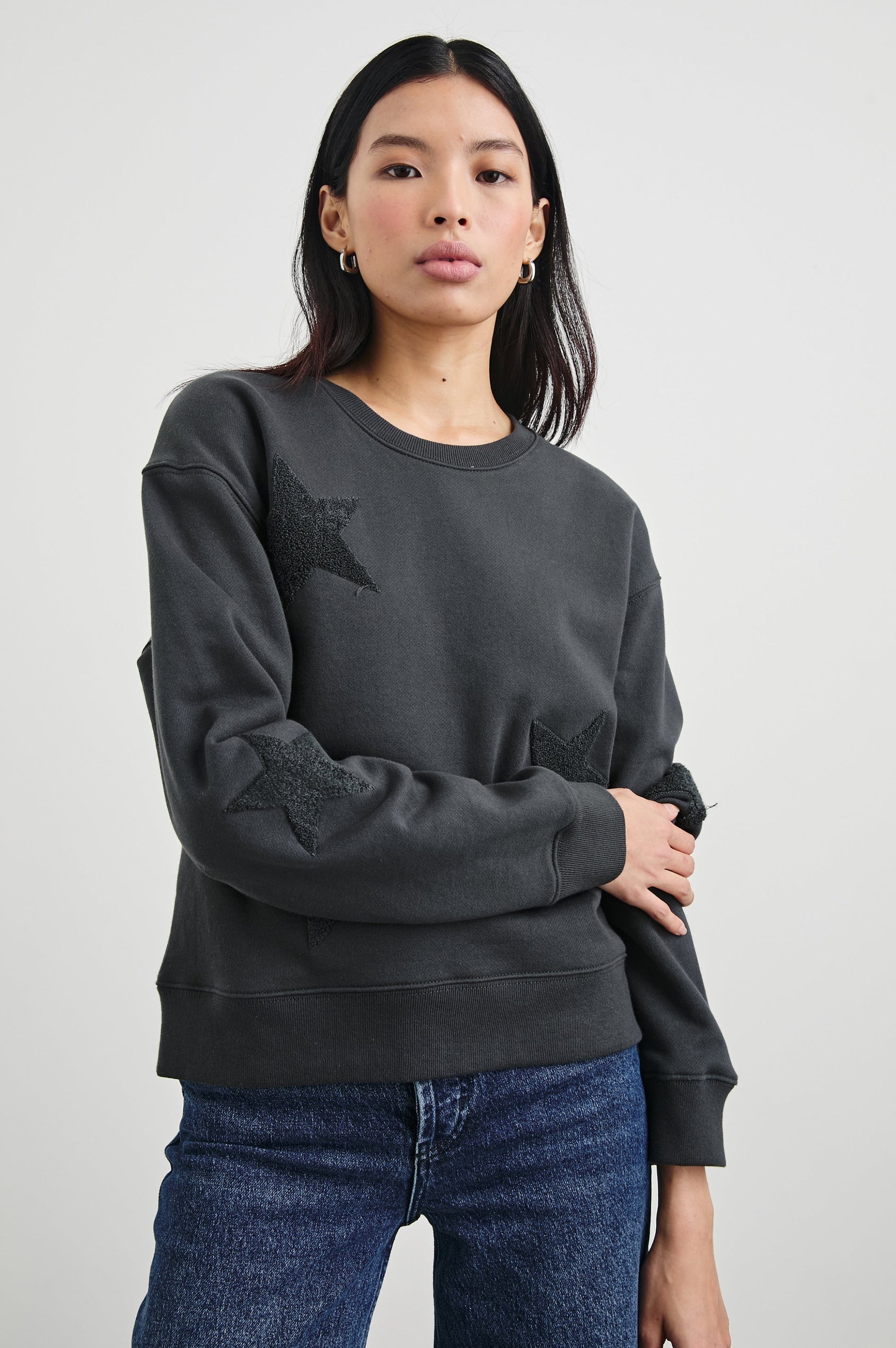 Sonia Long-Sleeve Sweatshirt with a Crew Neck and Charcoal Patch Stars in Washed Black Colorway - Front View Featured on Model