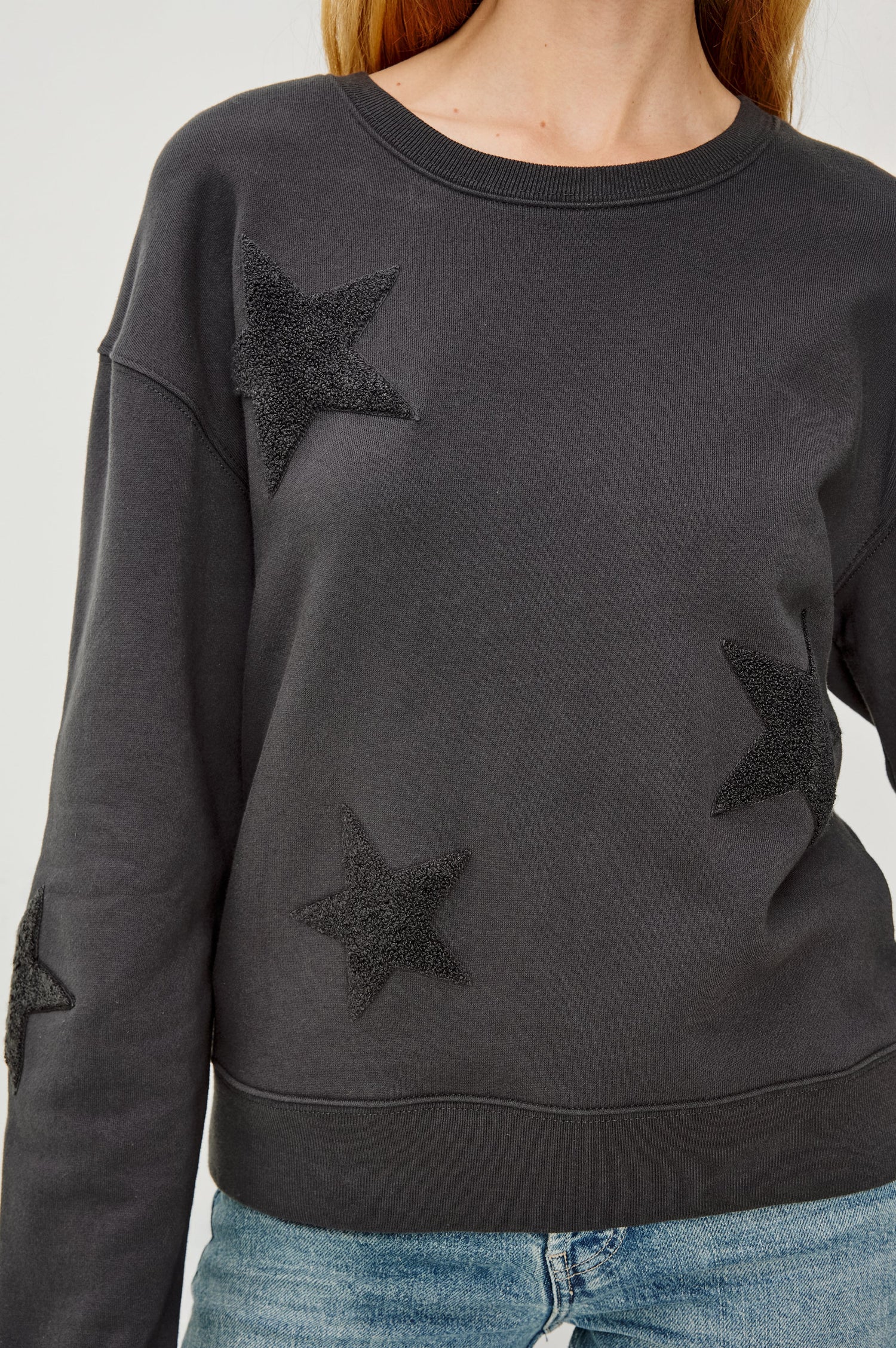 Sonia Long-Sleeve Sweatshirt with a Crew Neck and Charcoal Patch Stars in Washed Black Colorway - Close UP View Featured on Model
