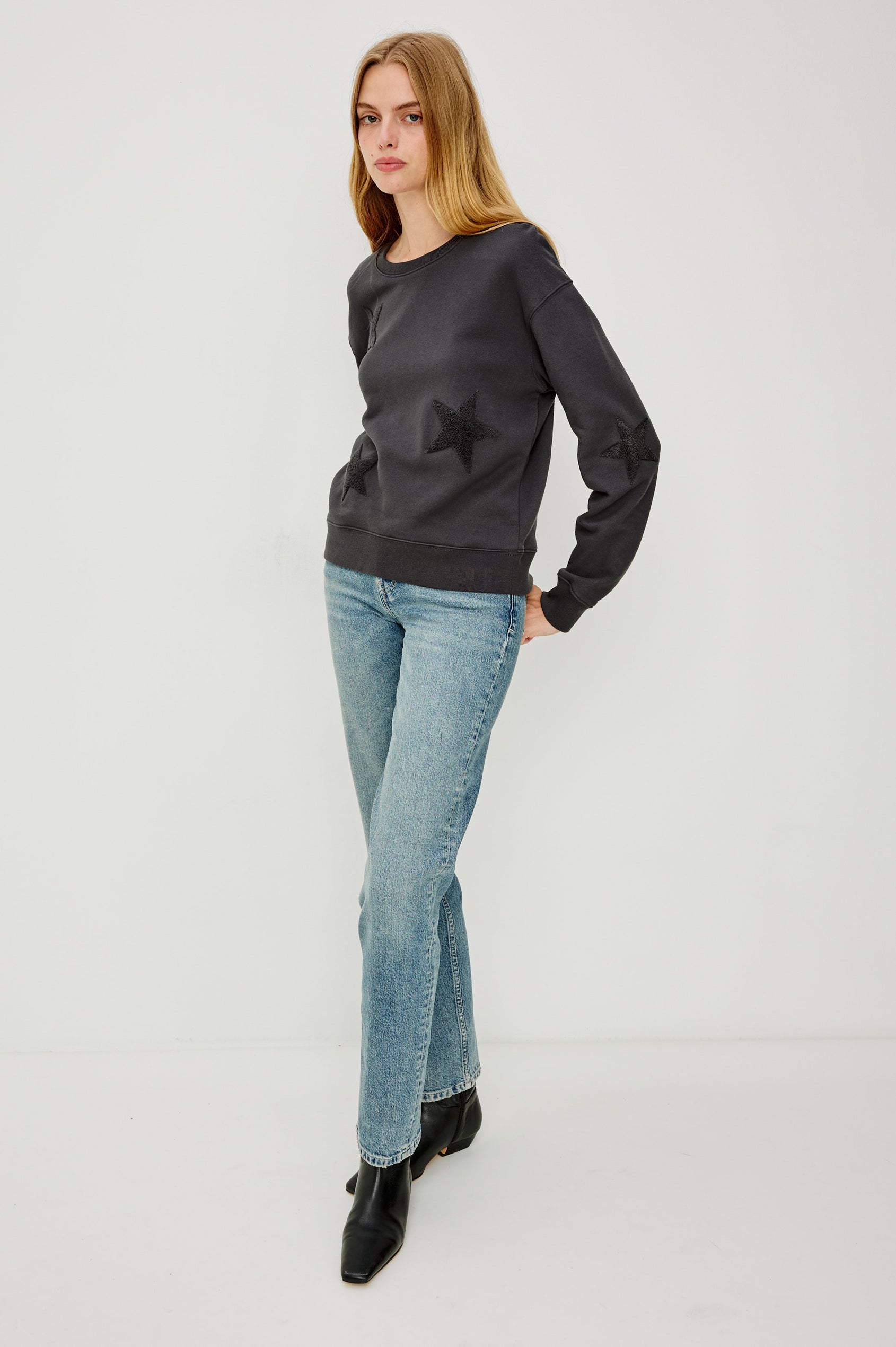 Sonia Long-Sleeve Sweatshirt with a Crew Neck and Charcoal Patch Stars in Washed Black Colorway - Full Body Front View Featured on Model