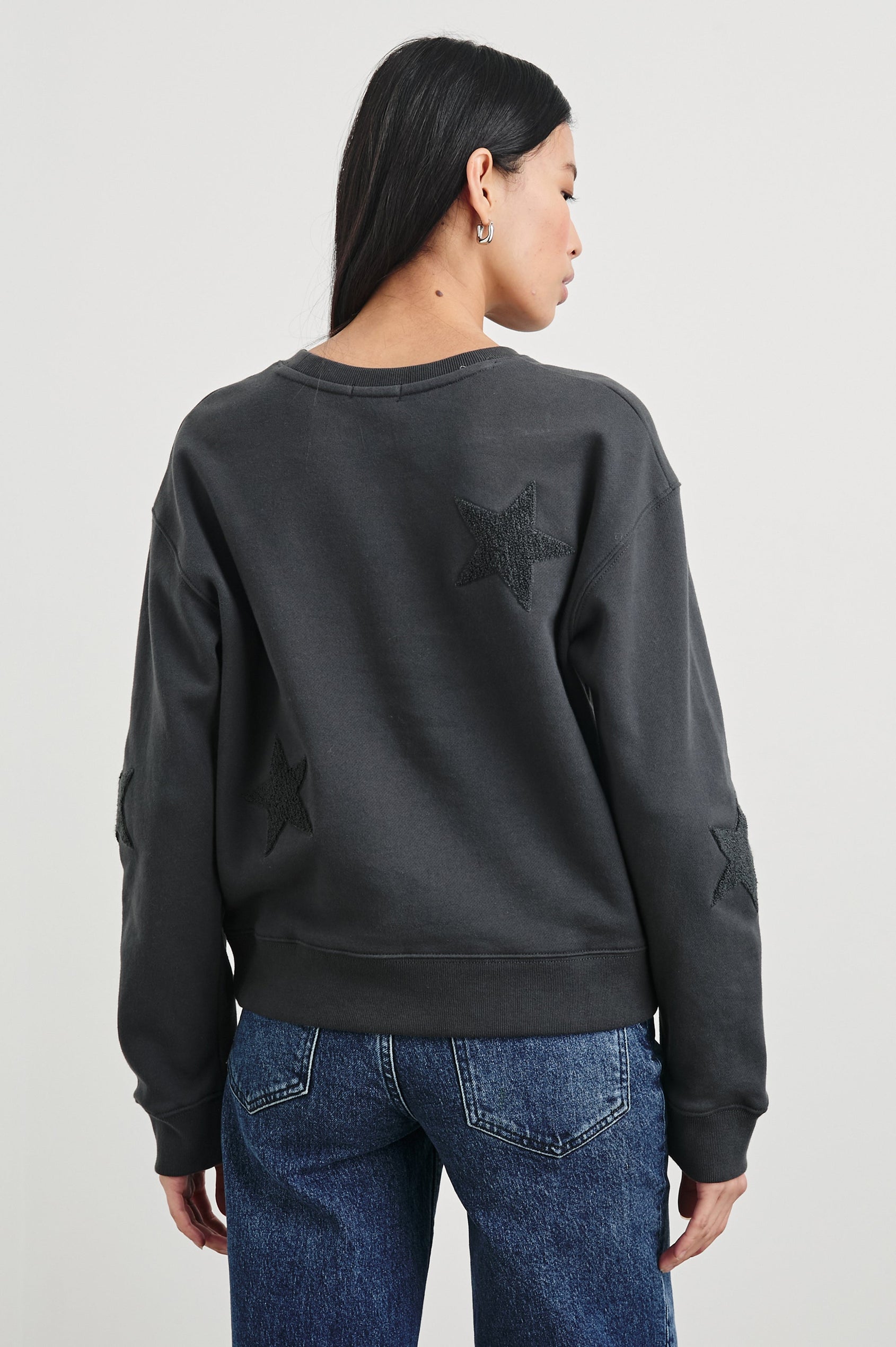 Sonia Long-Sleeve Sweatshirt with a Crew Neck and Charcoal Patch Stars in Washed Black Colorway - Back View Featured on Model