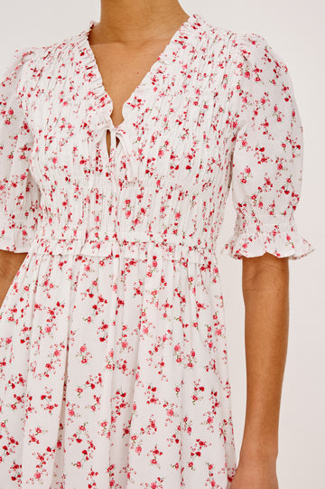 Sonica Midi Dress in Cotton With Fitted Smocked Bodice V-Neckline With Self-Ties Short Puff Sleeves and Single Tiered A-Line Skirt in Rouge Romantic Colorway - Full Body Front View Featured on Model